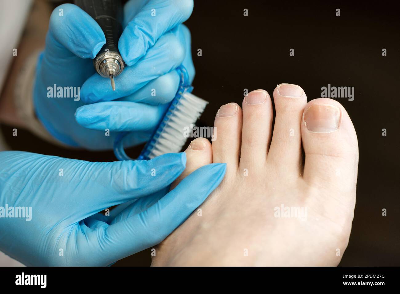 Hardware pedicure procedure closeup. Сhiropodist master processes toes