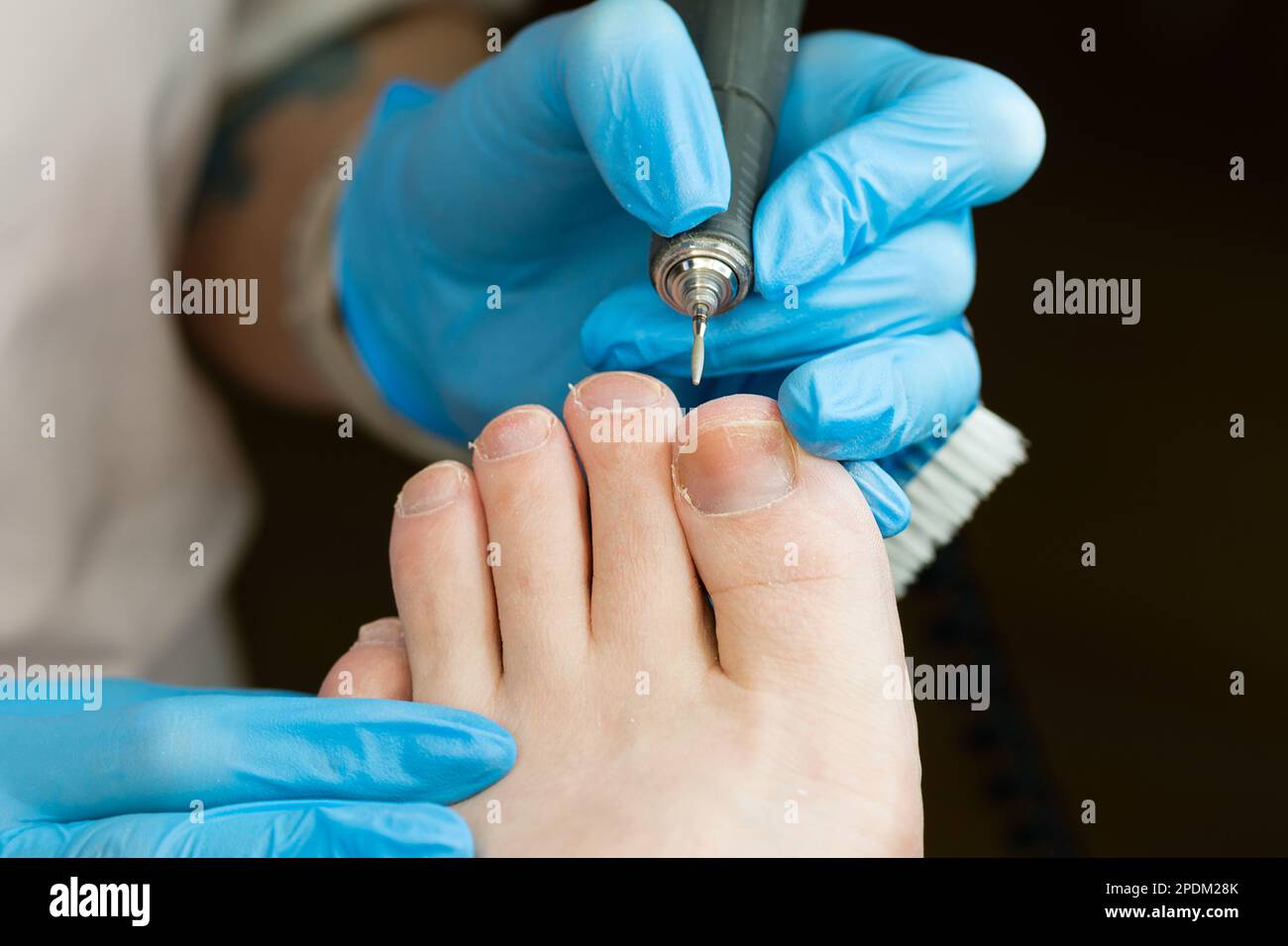 Hardware pedicure procedure closeup. Сhiropodist master processes toes