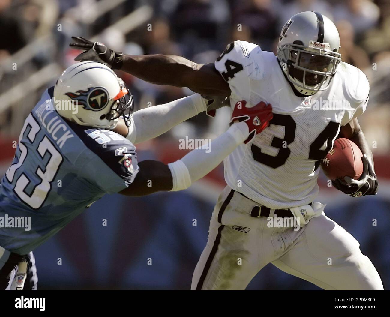Oakland Raiders runningback LaMont Jordan (34) tries to escape from  Tennessee Titans linebacker Keith Bulluck (53) in the first quarter in  Nashville, Tenn., on Sunday, Oct. 30, 2005. (AP Photo/Mark Humphrey Stock  Photo - Alamy