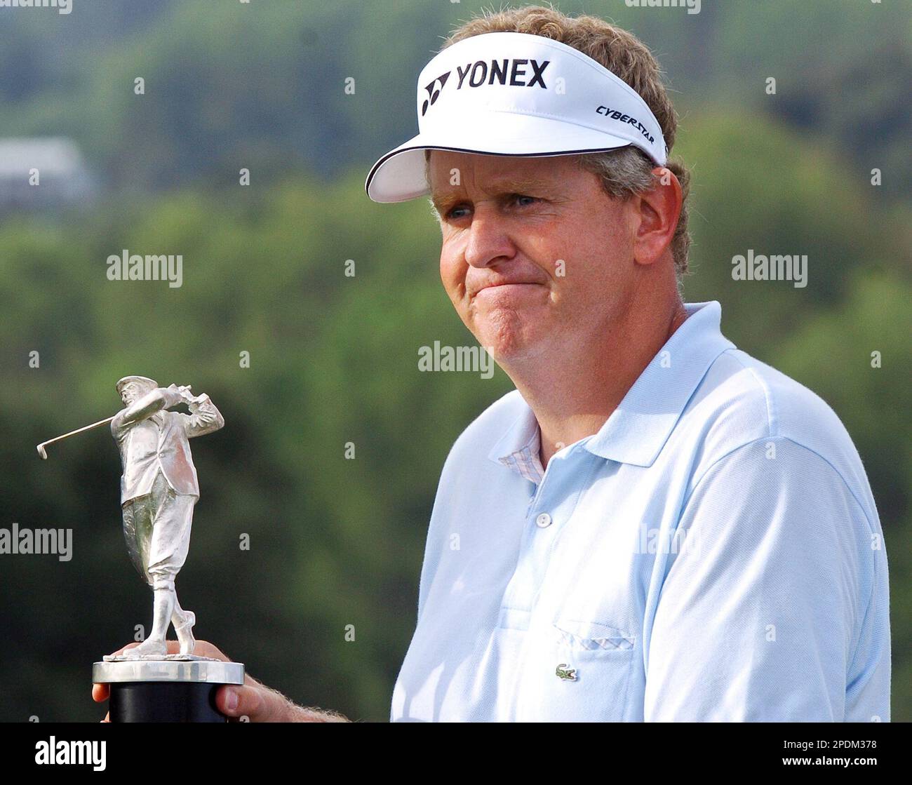 Scotland's Colin Montgomerie holds a trophy after winning the European Tour  Order of Merit for the eight time on the final day of the Volvo Masters  Championships at the Club de Golf