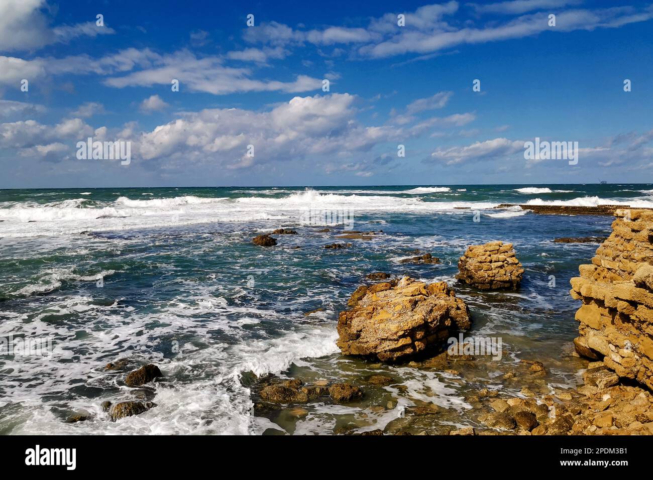 Ruins ancient city on Mediterranean coast. Colorful seascape in sunny weather at coast Stock Photo