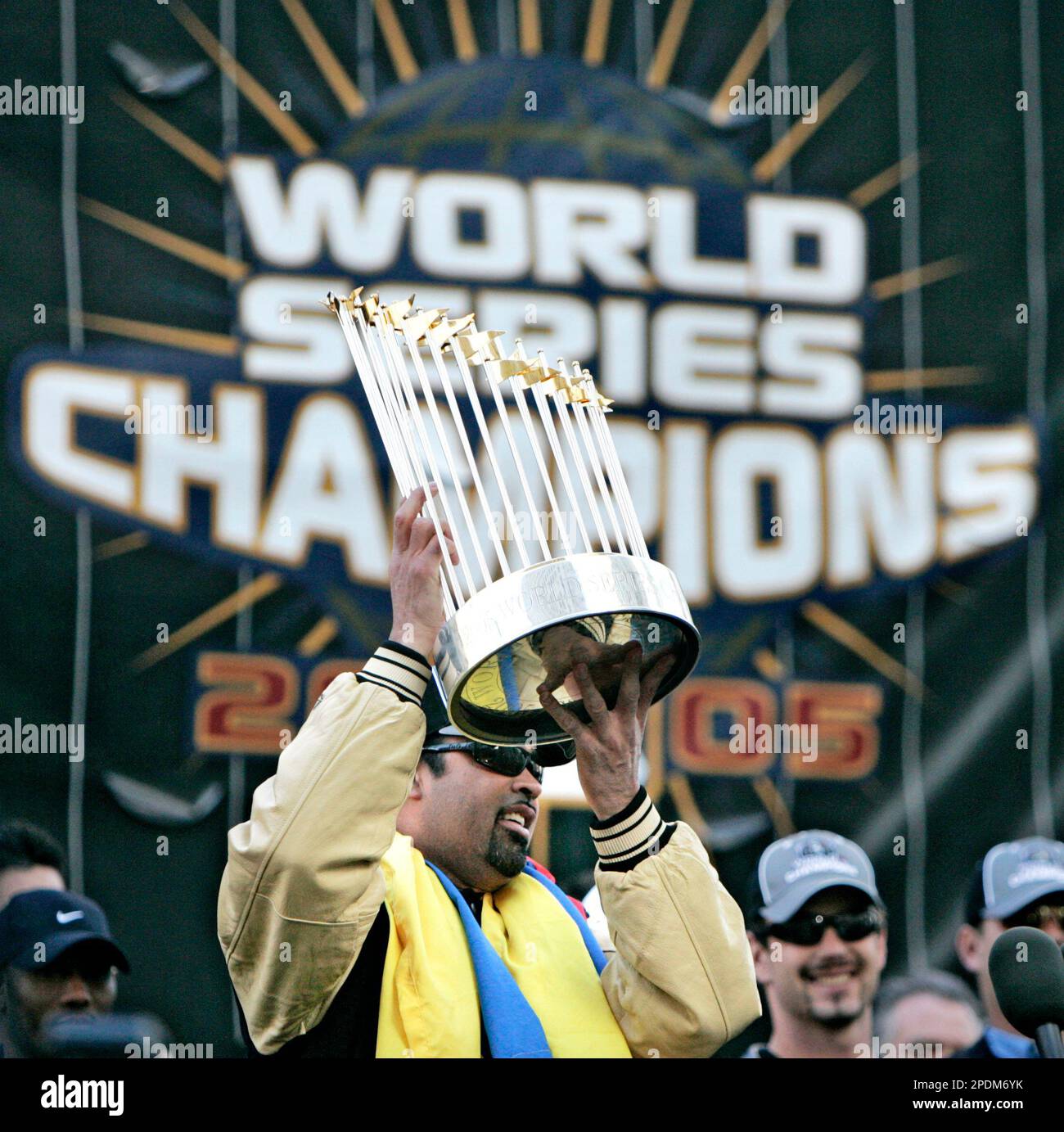 Chicago White Sox manager Ozzie Guillen holds up the World Series trophy  for the crowd gathered during a celebration Friday, Oct. 28, 2005, in  downtown Chicago for the team's World Series victory. (