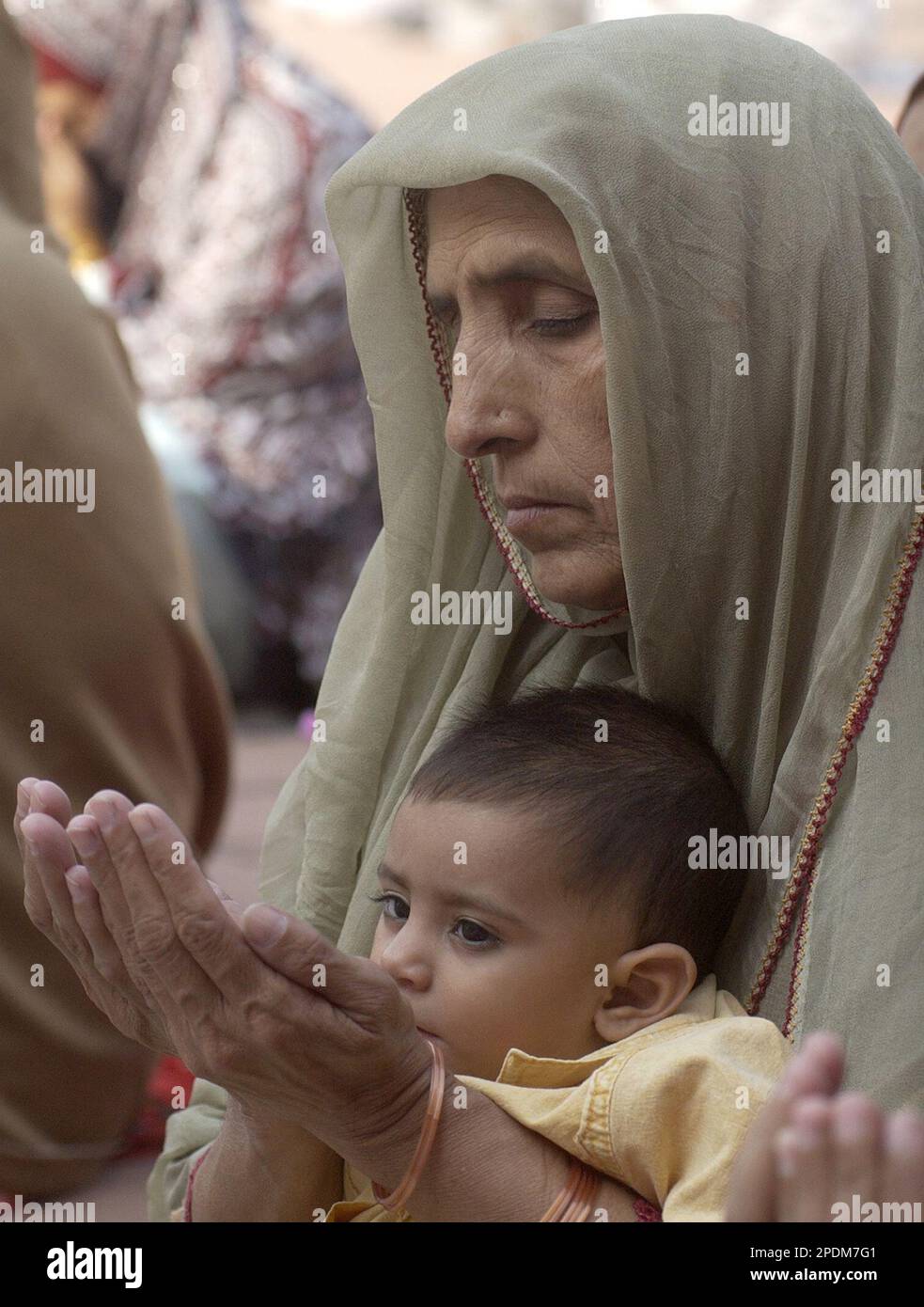 A Pakistani woman prays during Jumatul Wida, the last Friday prayers of ...