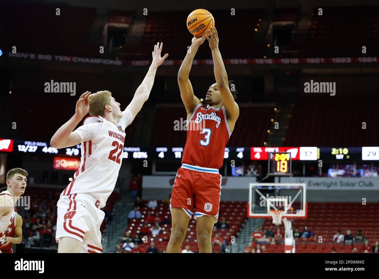 Madison, WI, USA. 14th Mar, 2023. Bradley Braves guard Zek Montgomery (3) takes a jump shot over Wisconsin Badgers forward Steven Crowl (22) during the NCAA basketball NIT First Round game between the Bradley Braves and the Wisconsin Badgers at the Kohl Center in Madison, WI. Darren Lee/CSM/Alamy Live News Stock Photo