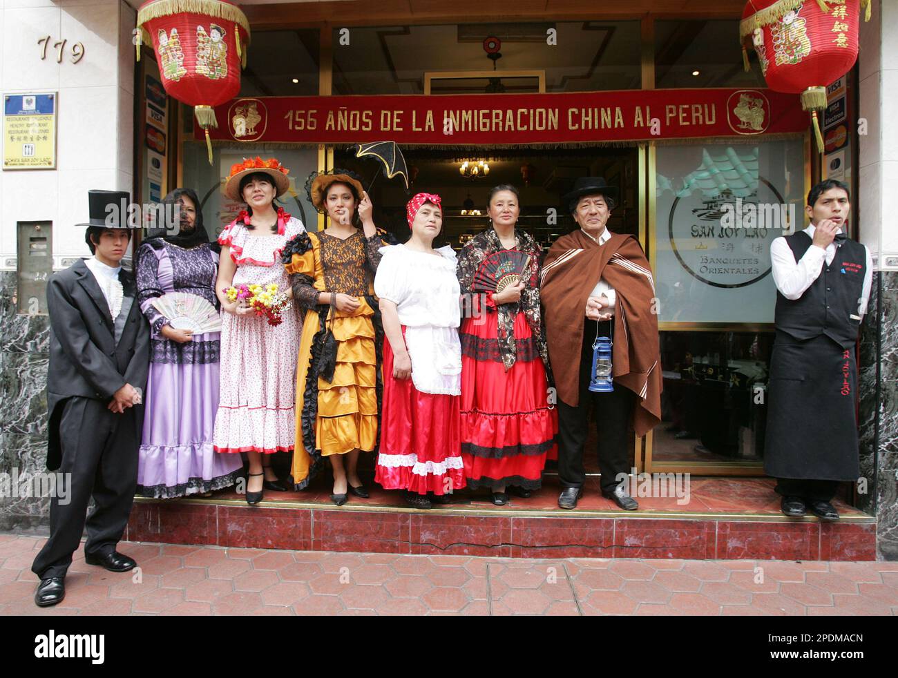 Peruvian descendants of Chinese emigrants pose in front of 