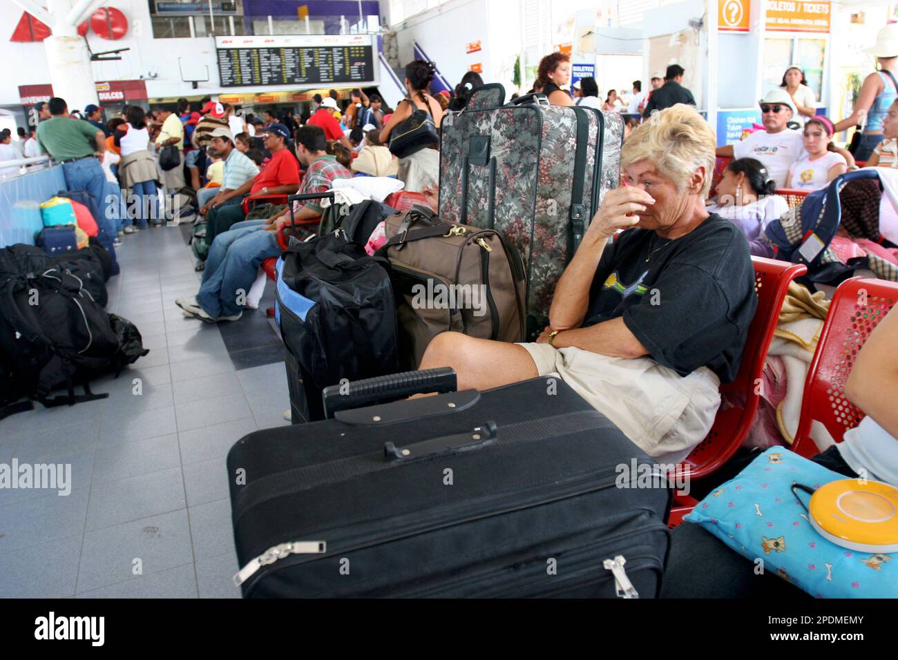 Tourists wait at a bus station for an opportunity to leave the 