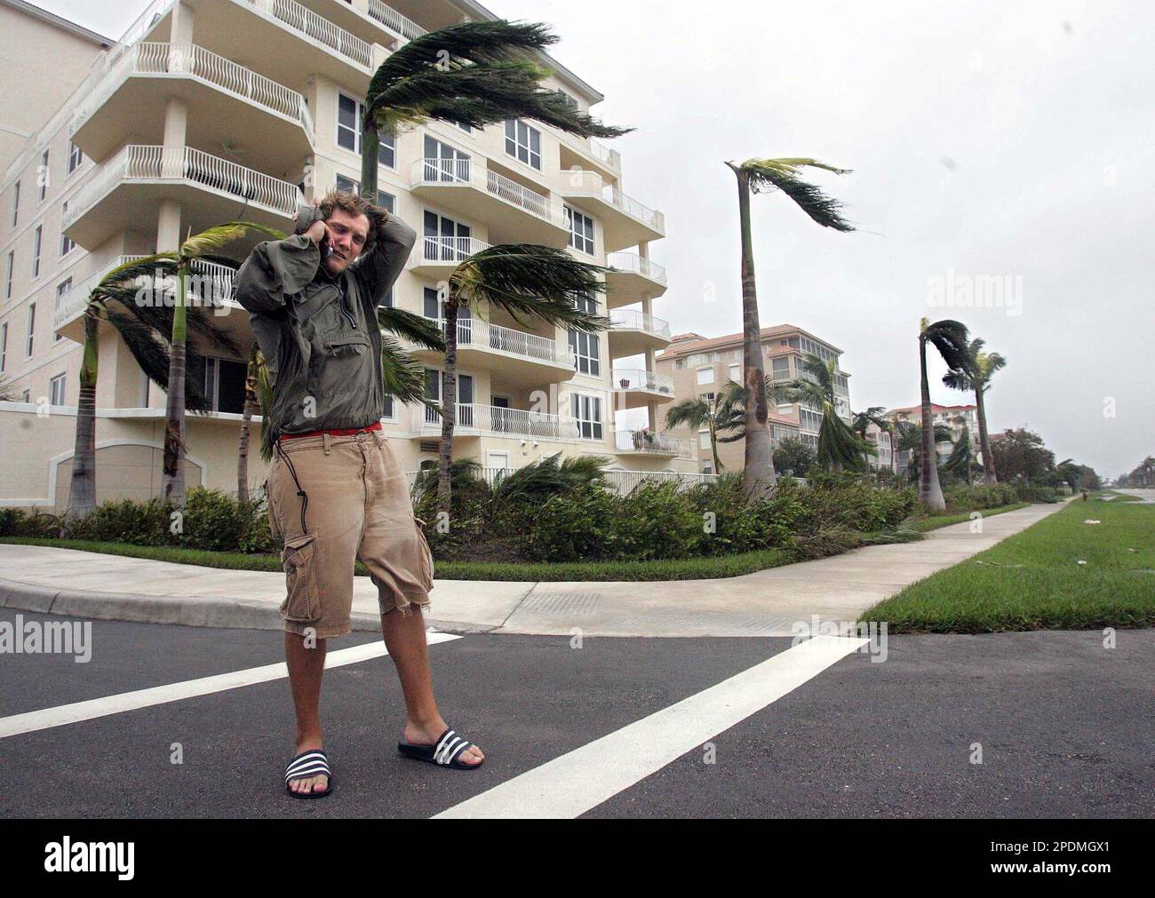 Marco Island resident Joe Wabiszewski reports some observed damage to  friends using his cell phone as the tail end of Hurricane Wilma passed over Marco  Island, Fla., Monday, Oct. 24, 2005. (AP, image size:1300x1011