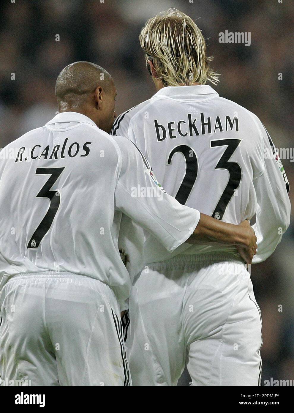 Real Madrid's David Beckham of England, right is consoled by Roberto Carlos  of Brazil as he leaves the field after being sent off during a Spanish  league soccer match against Valencia at