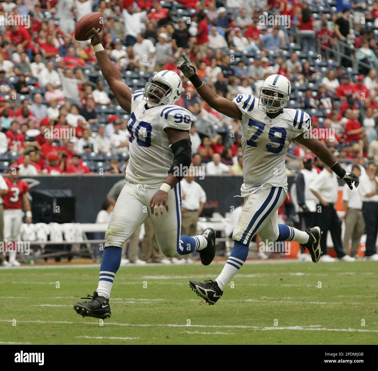 Tampa Bay Buccaneers fullback Mike Alstott (40) is tripped up by  Indianapolis Colts' Raheem Brock (79), while Colts' Montae Reagor (90)  chases during the first quarter Monday night Oct. 6, 2003 in