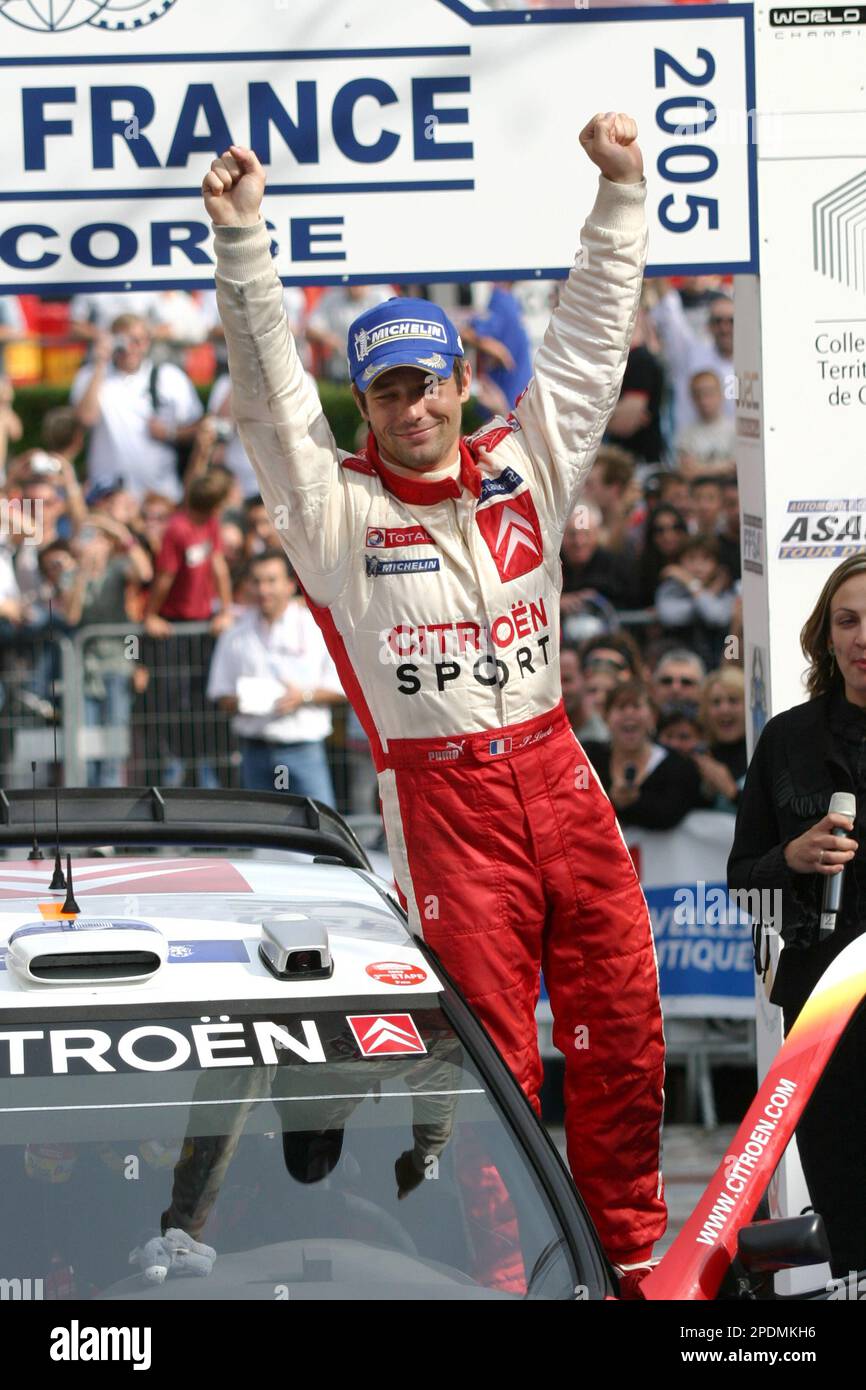 Sebastien Loeb of France raises his arms after winning the Tour of