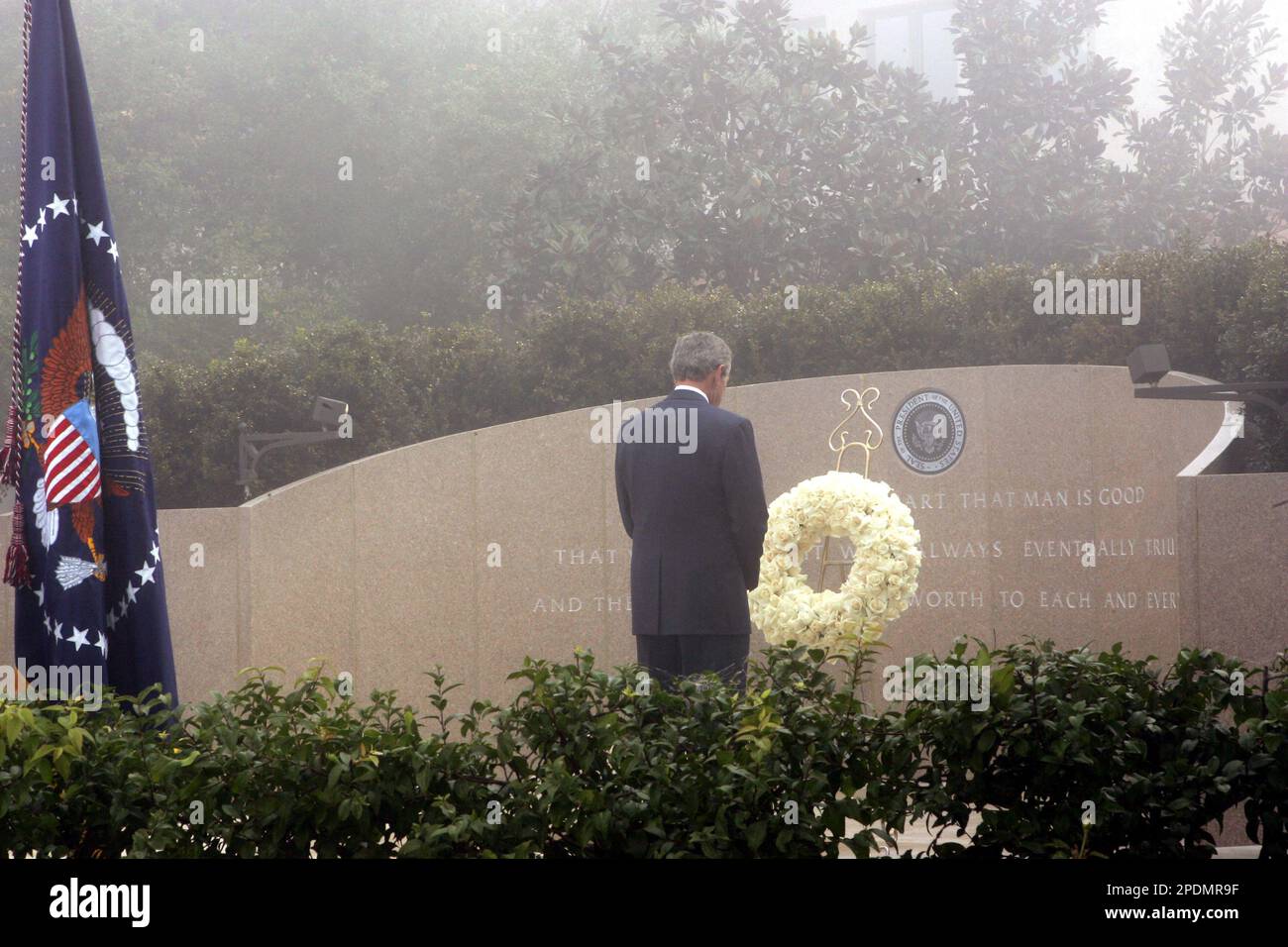 President Bush stands after laying a wreath in honor of the late ...