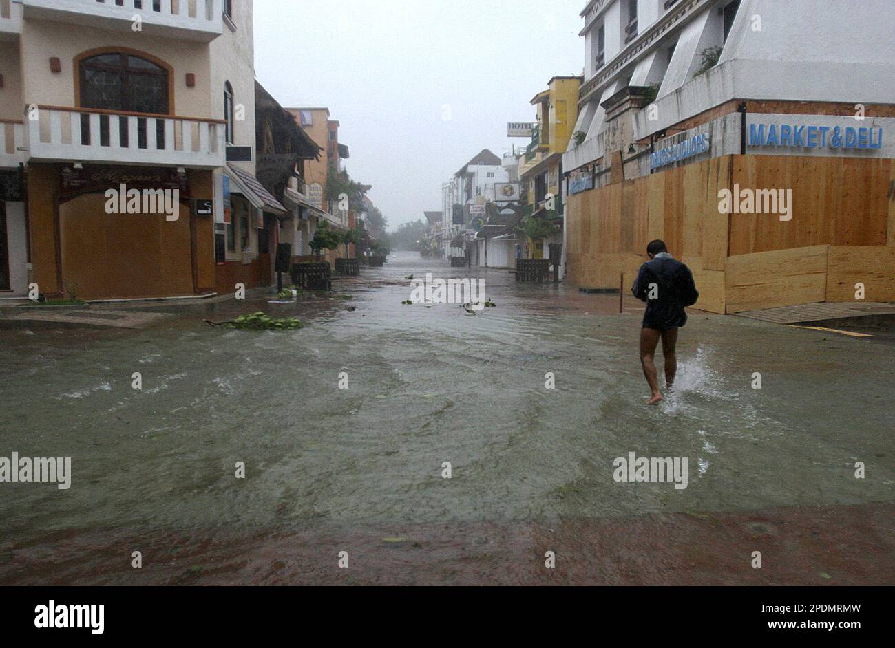 A man walks in the flooded streets of Playa del Carmen, Mexico as Hurricane  Wilma makes landfall on Friday Oct. 21, 2005. The fearsome core of Wilma  slammed into the island of, image size:1300x942