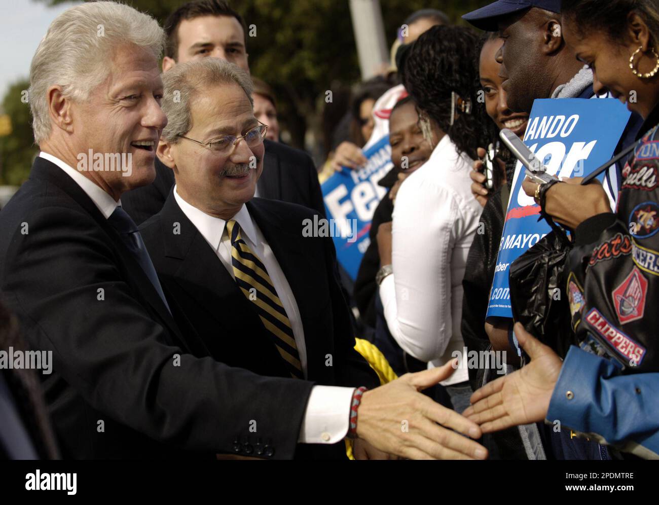 Supporters of mayoral candidate Fernando Ferrer, second left, clamour for a  chance to greet Ferrer and former President Bill Clinton as they campaign  together in the Bronx borough of New York Thursday