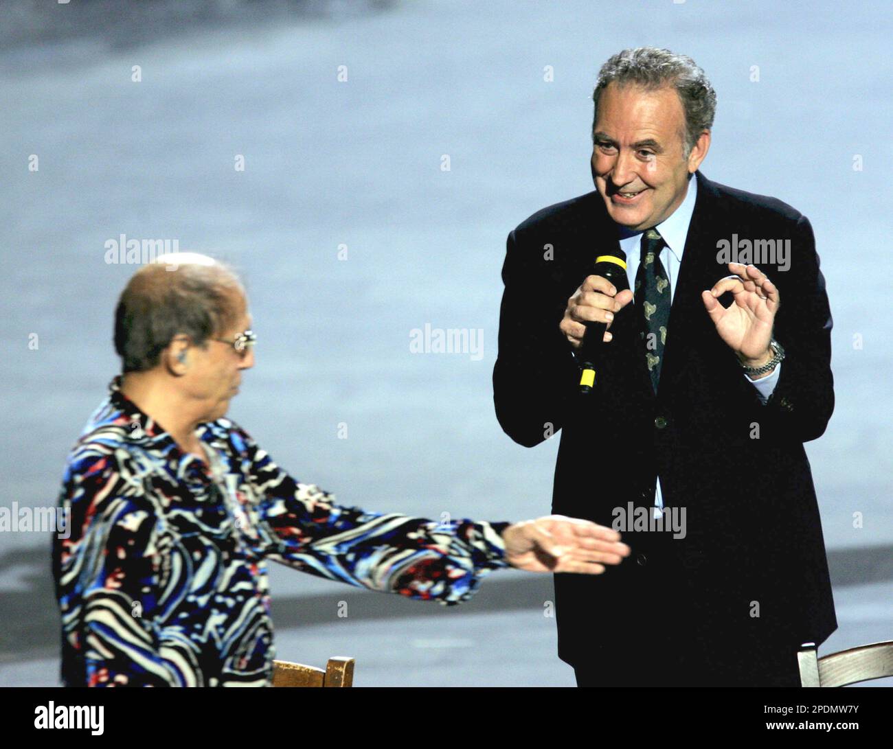 Adriano Celentano left and Michele Santoro speak to each other