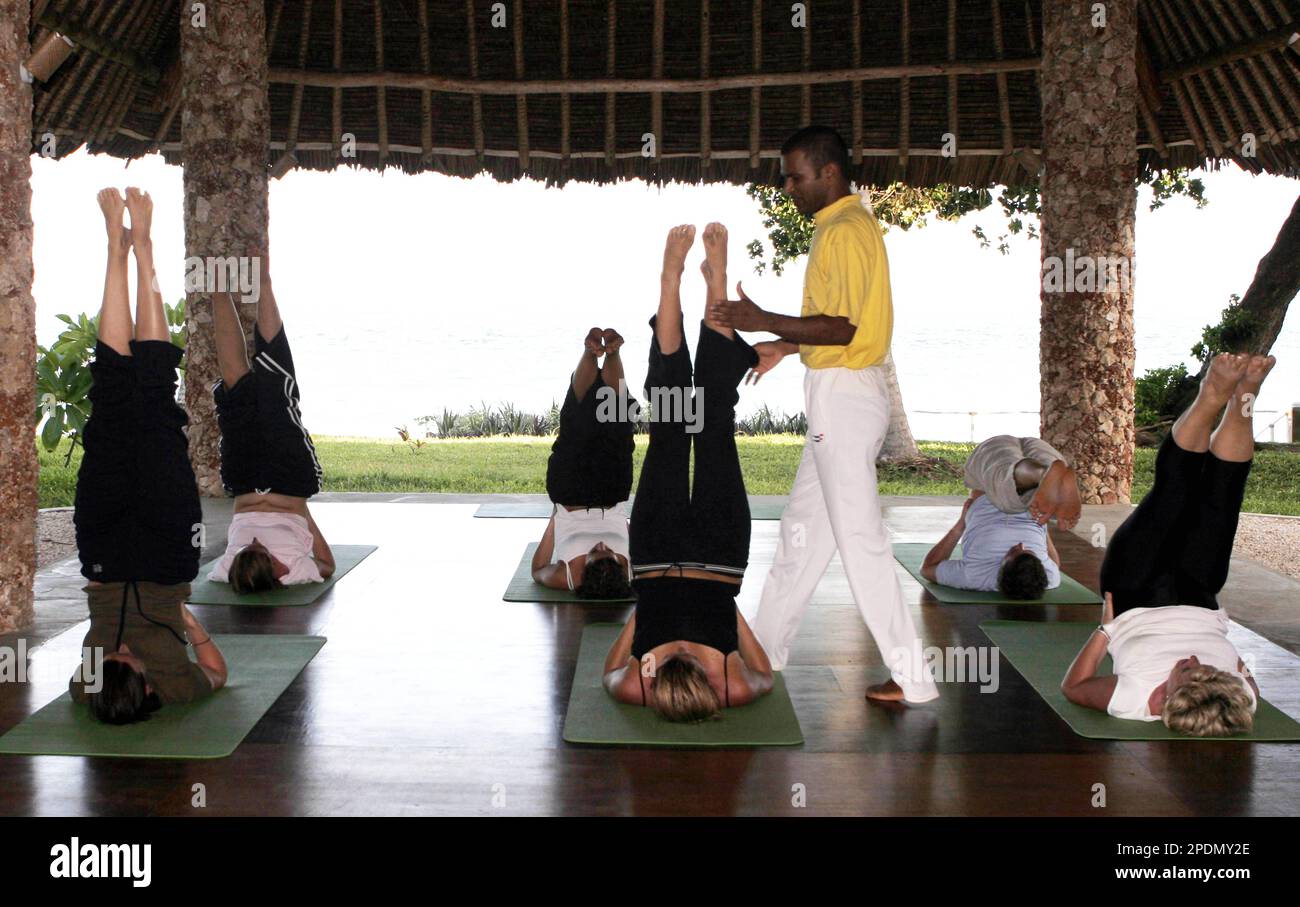 Yoga therapist Dayananda from Bangalore India helps a guest