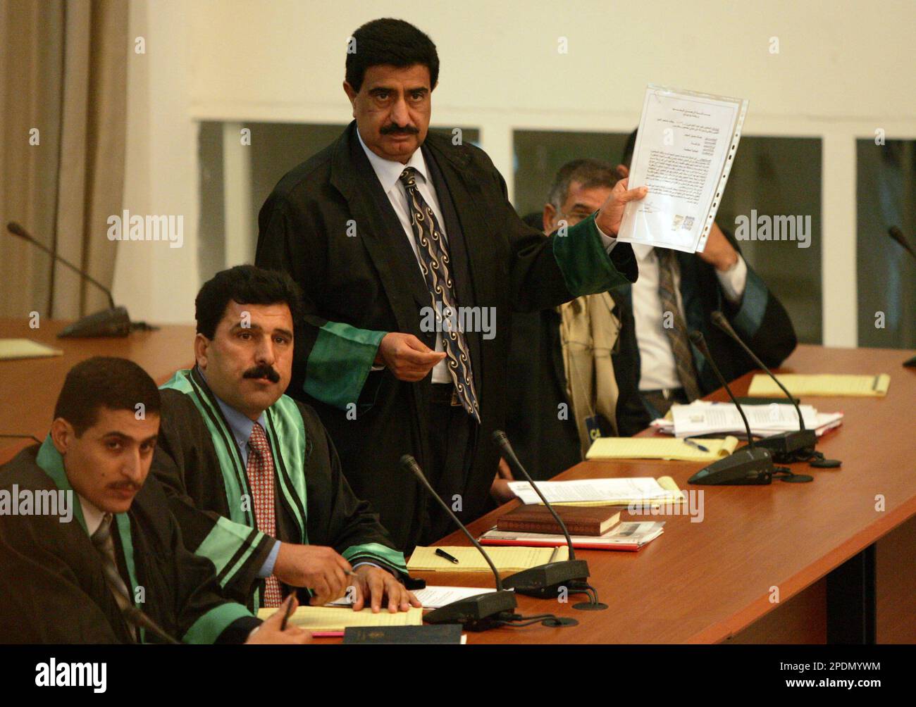 Khamees Hameed AlUbaidi, a lawyer for Saddam Hussein, shows a document