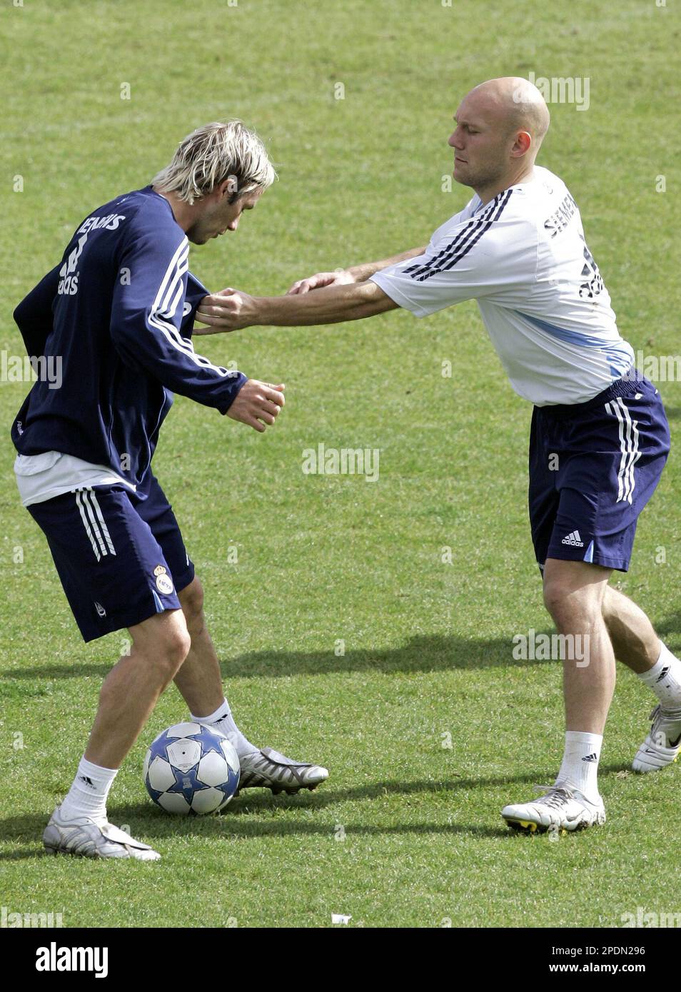 England's Real Madrid player David Beckham, left, duels for the ball with  his teammate Thomas Gravesen from Denmark during their training at the Las  Rozas training complex on the outskirts of Madrid,