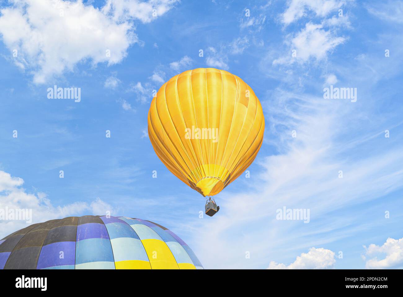 Colorful hot air balloon flying over blue sky with white clouds Stock ...