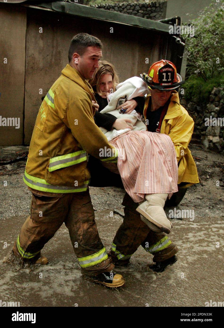 Burbank firefighters Jim Goldstein, right, and Dave Johnson, carry