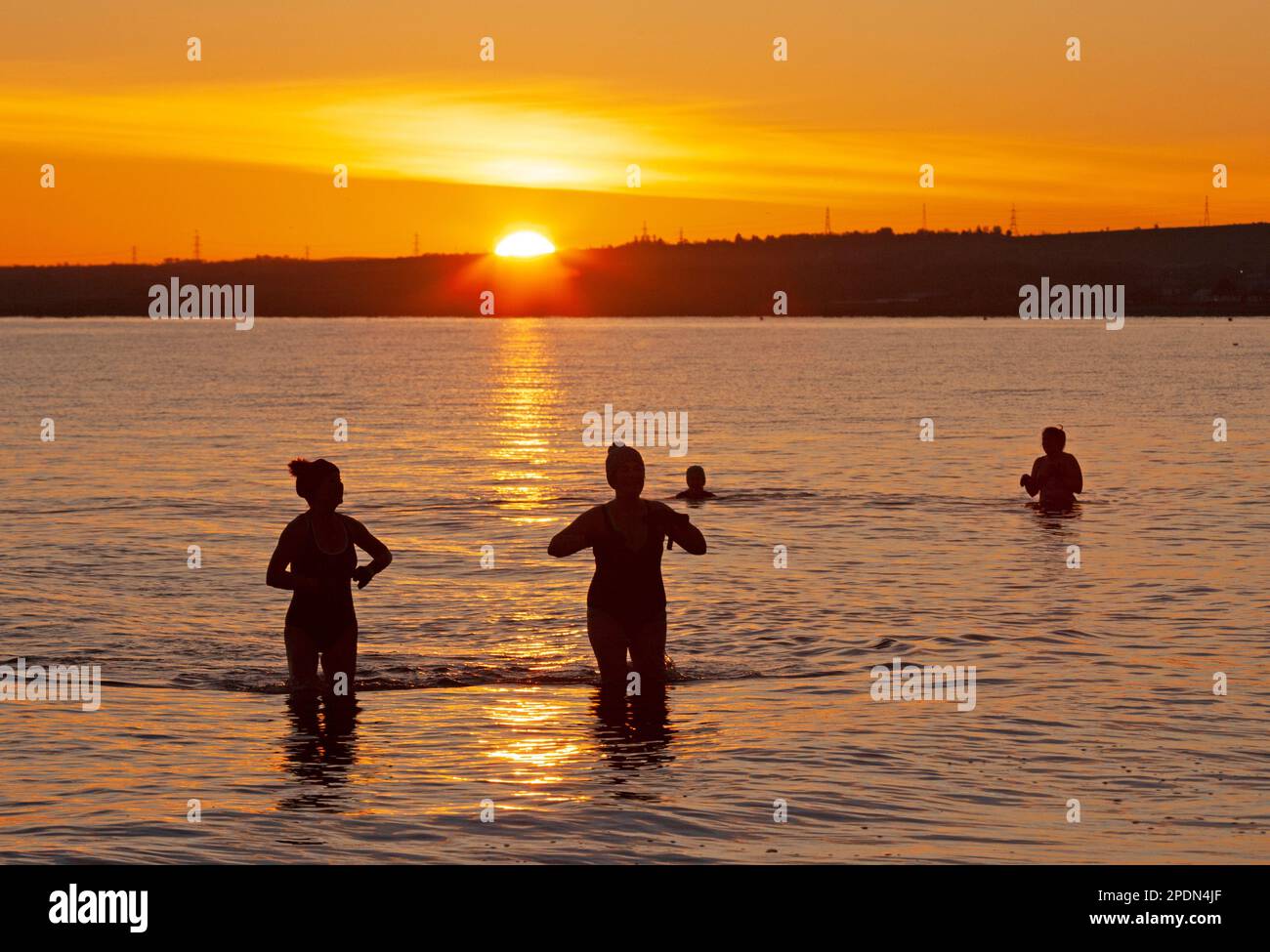 Portobello, Edinburgh, Scotland, UK. 15th March 2023. Temperature minus 4 degrees centigrade made for a freezing dawn at the seaside by the Firth of Forth for those brave enough to venture out for a cold water swim. Within an hour the sun had disappered behind a veil of cloud. Credit: Archwhite/alamy live news. Stock Photo