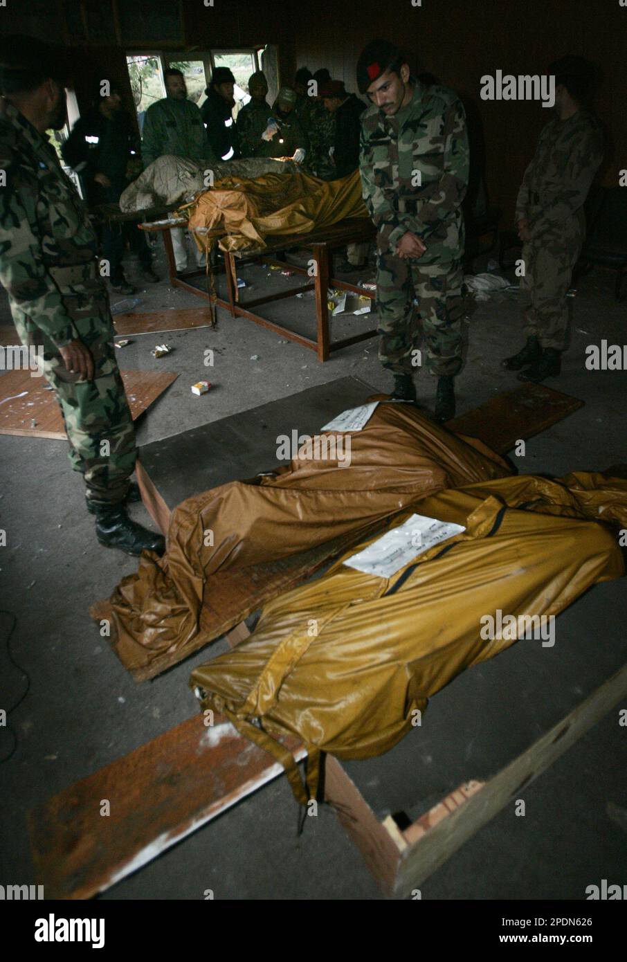 Pakistani army officers bring the bodies of 6 comrades to a base in the