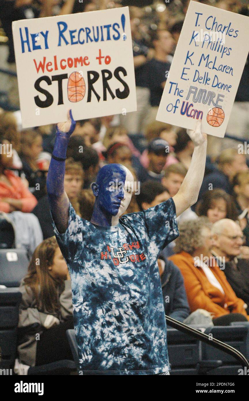 Connecticut women's basketball fan Dale Nosel holds up signs during the