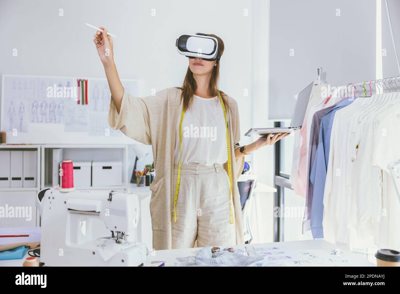 Costume designer using modern VR visual digital design technology in tailor studio Stock Photo