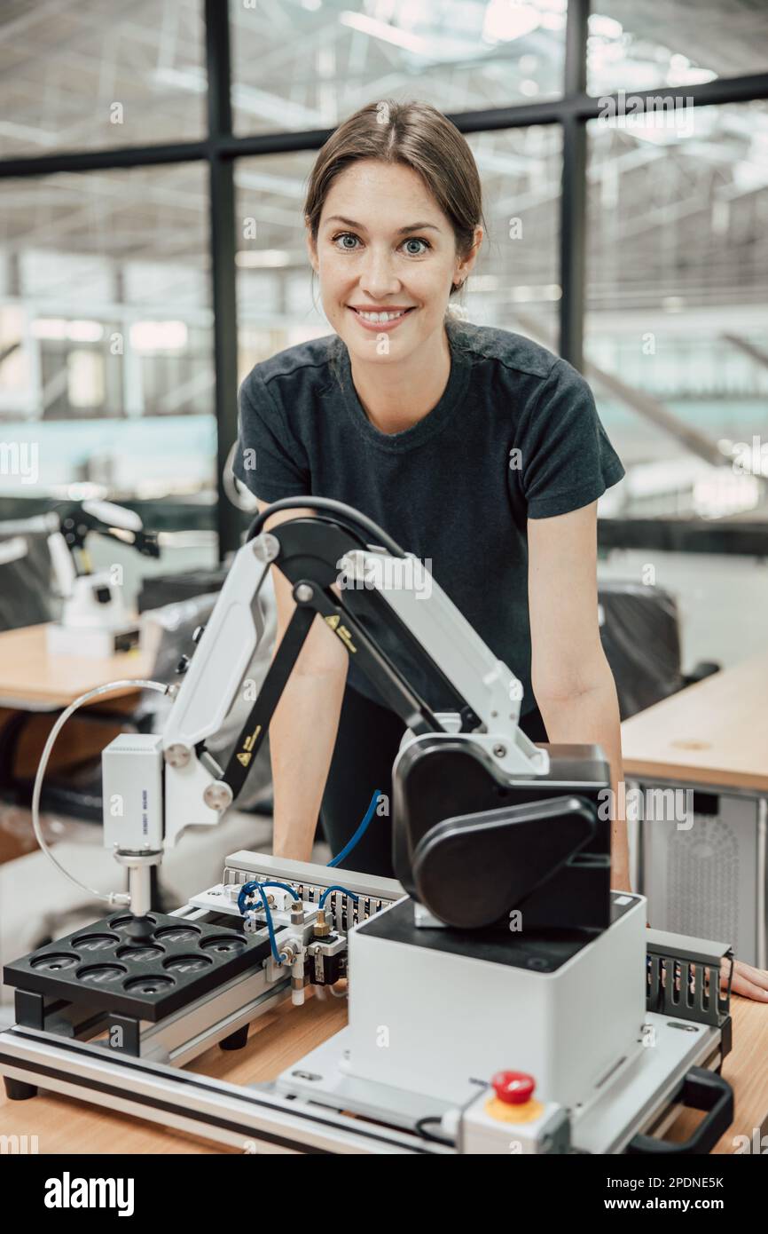 portrait smart woman robot engineer programmer work in robotic lab research and development team. Stock Photo