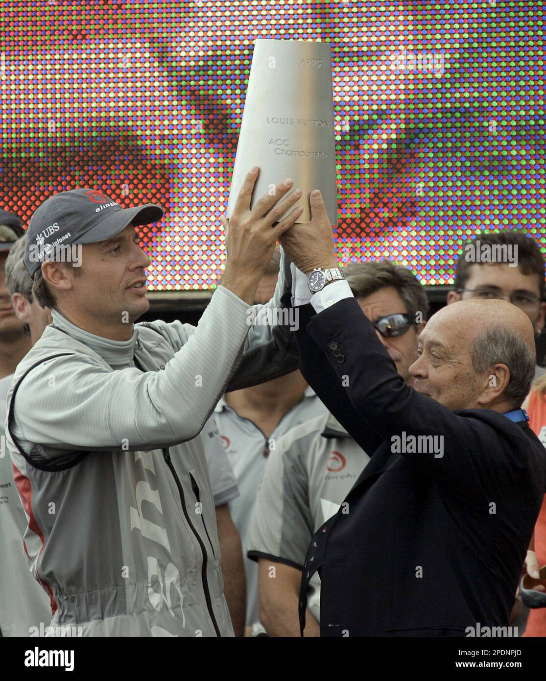 Alinghi's (SUI75) head of syndicate Ernesto Bertarelli, left, receives the Louis  Vuitton trophy from the hands of Agostino Ropolo, Chief executive officer  of L.V.M.H. (Louis Vuiton - Moet Hennessy) Italy during the