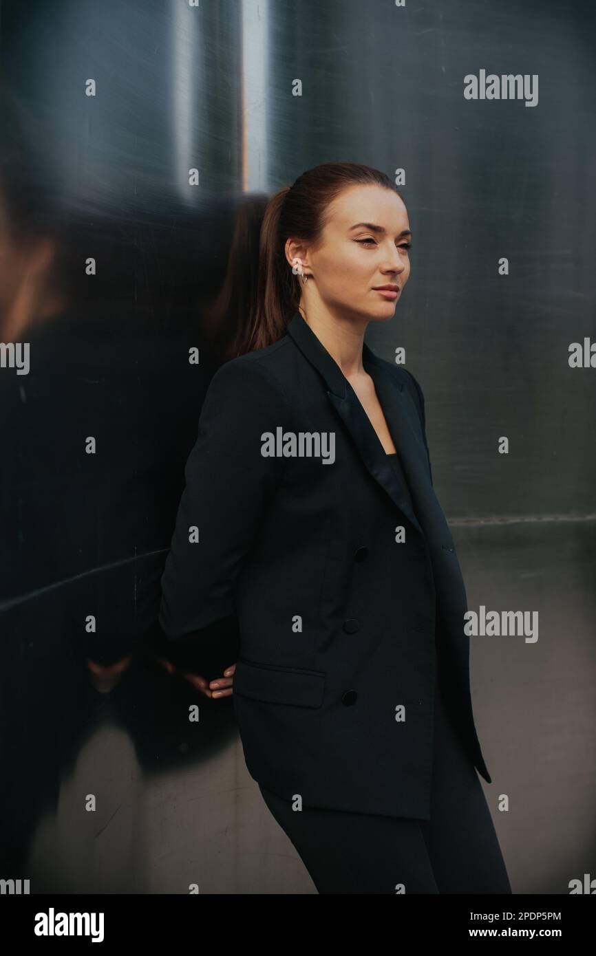 Fashion street style portrait of pretty girl in black suit. Beautiful ...
