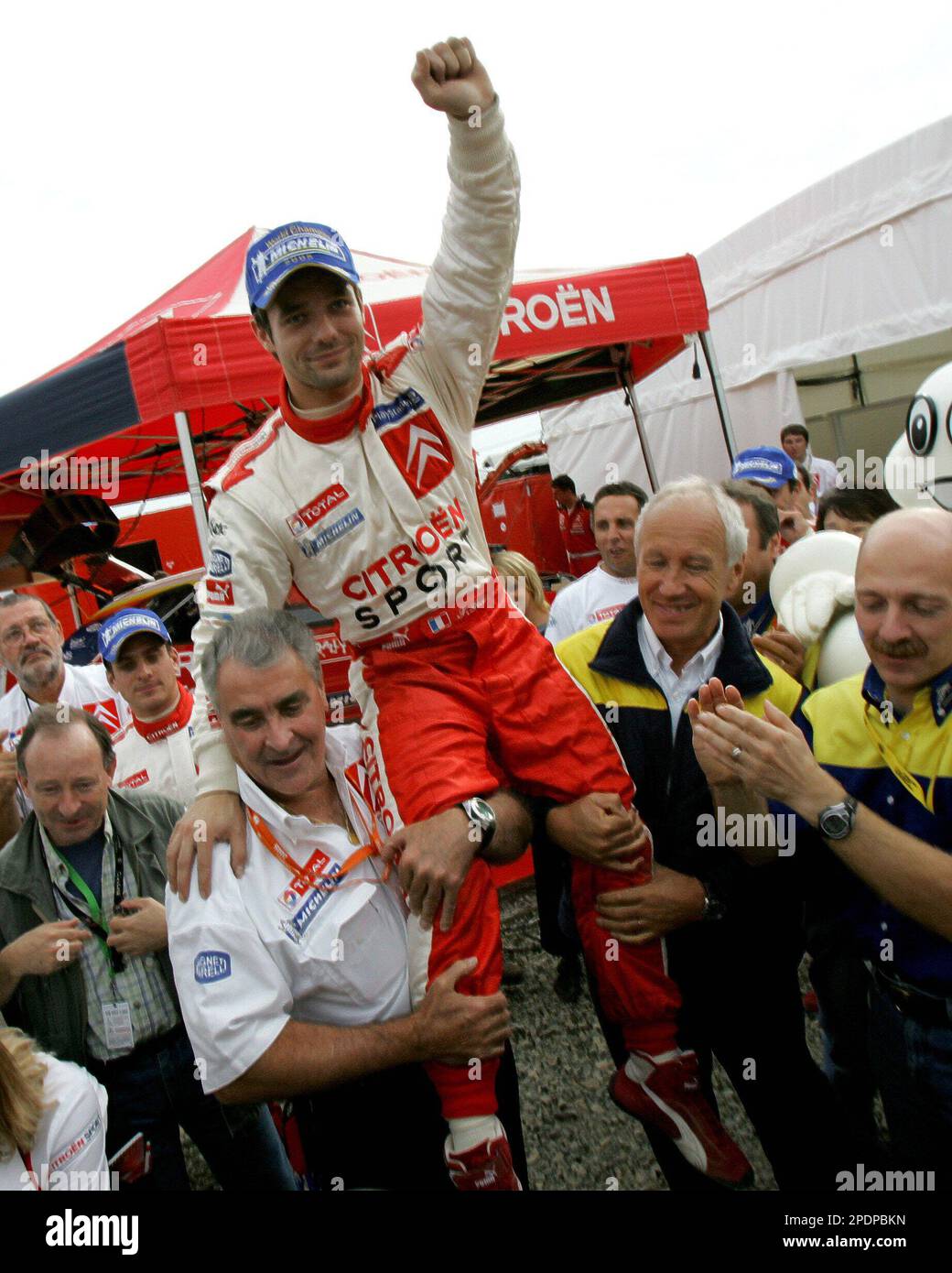 French driver Sebastien Loeb is lifted by Citroen team director Guy