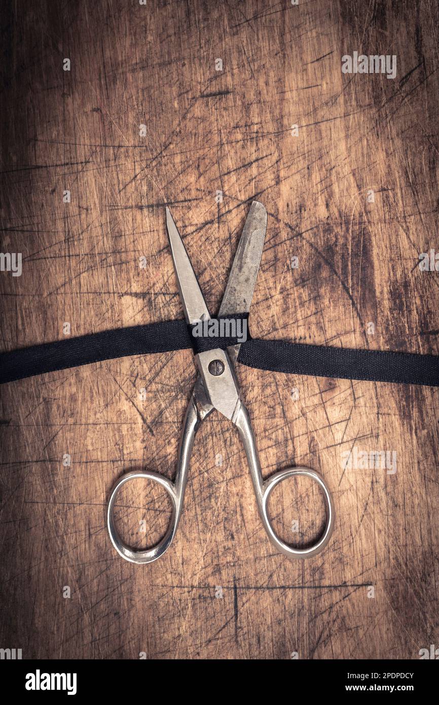 vintage black ribbon cutting scissors Stock Photo