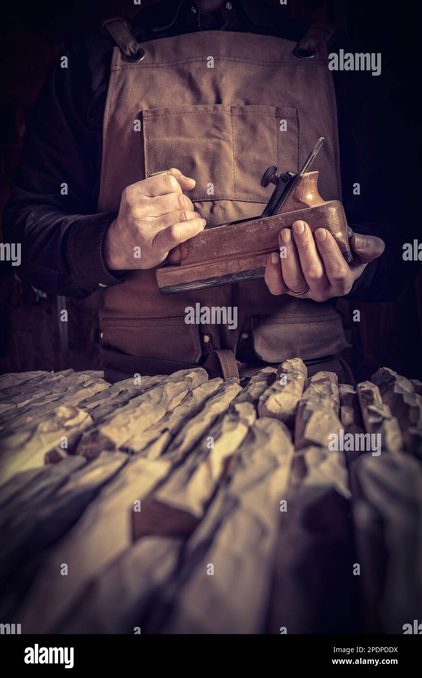 carpenter with leather apron holding a planer Stock Photo