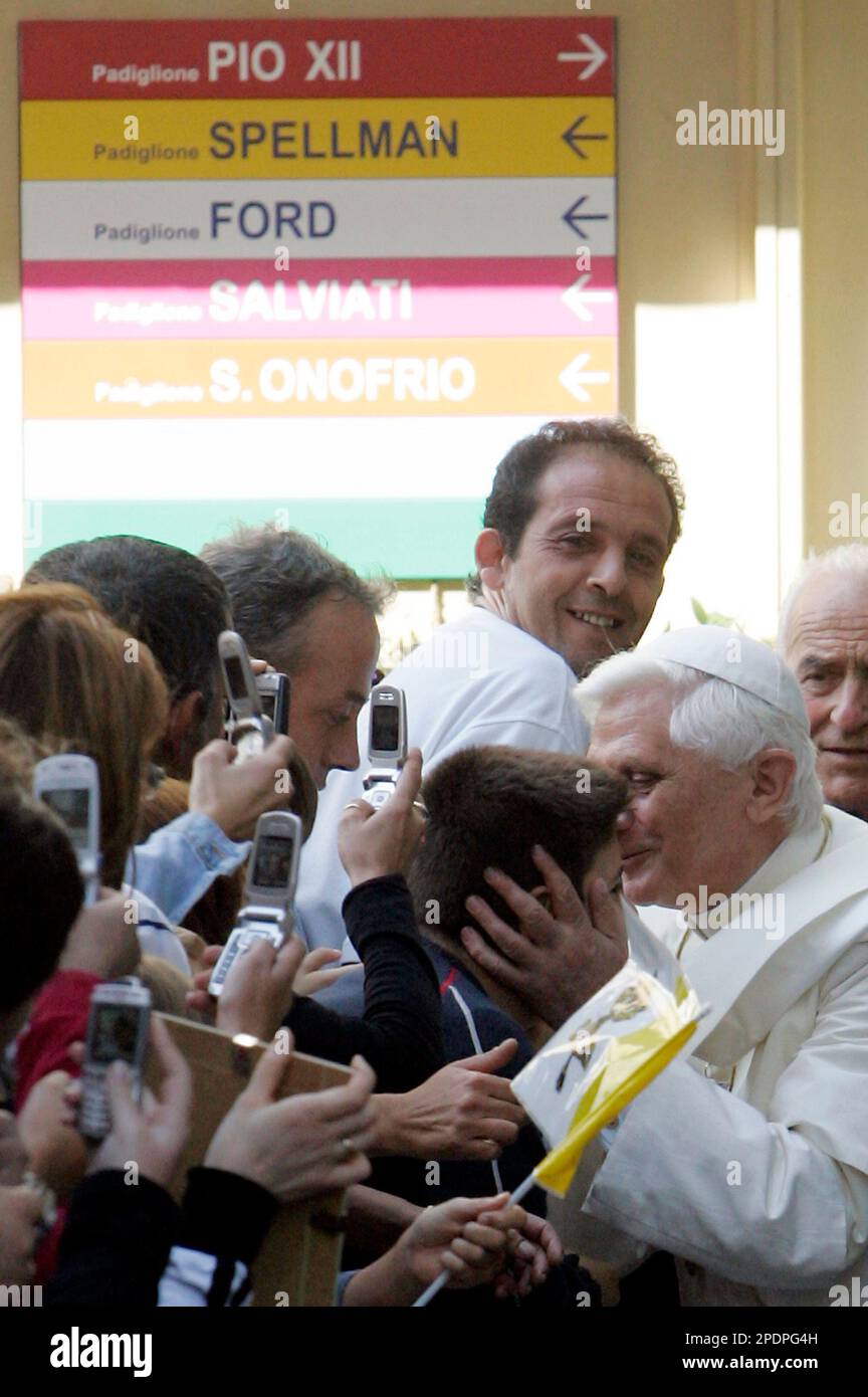 Pope Benedict XVI kisses a child upon his arrival at Bambino Gesu pediatric hospital in Rome, Friday, Sept. 30, 2005.The Pontiff visited Rome's main children's hospital Friday, blessing dozens of sick children and assuring their parents that he was spiritually close to them.(AP Photo/Pier Paolo Cito) Stock Photo