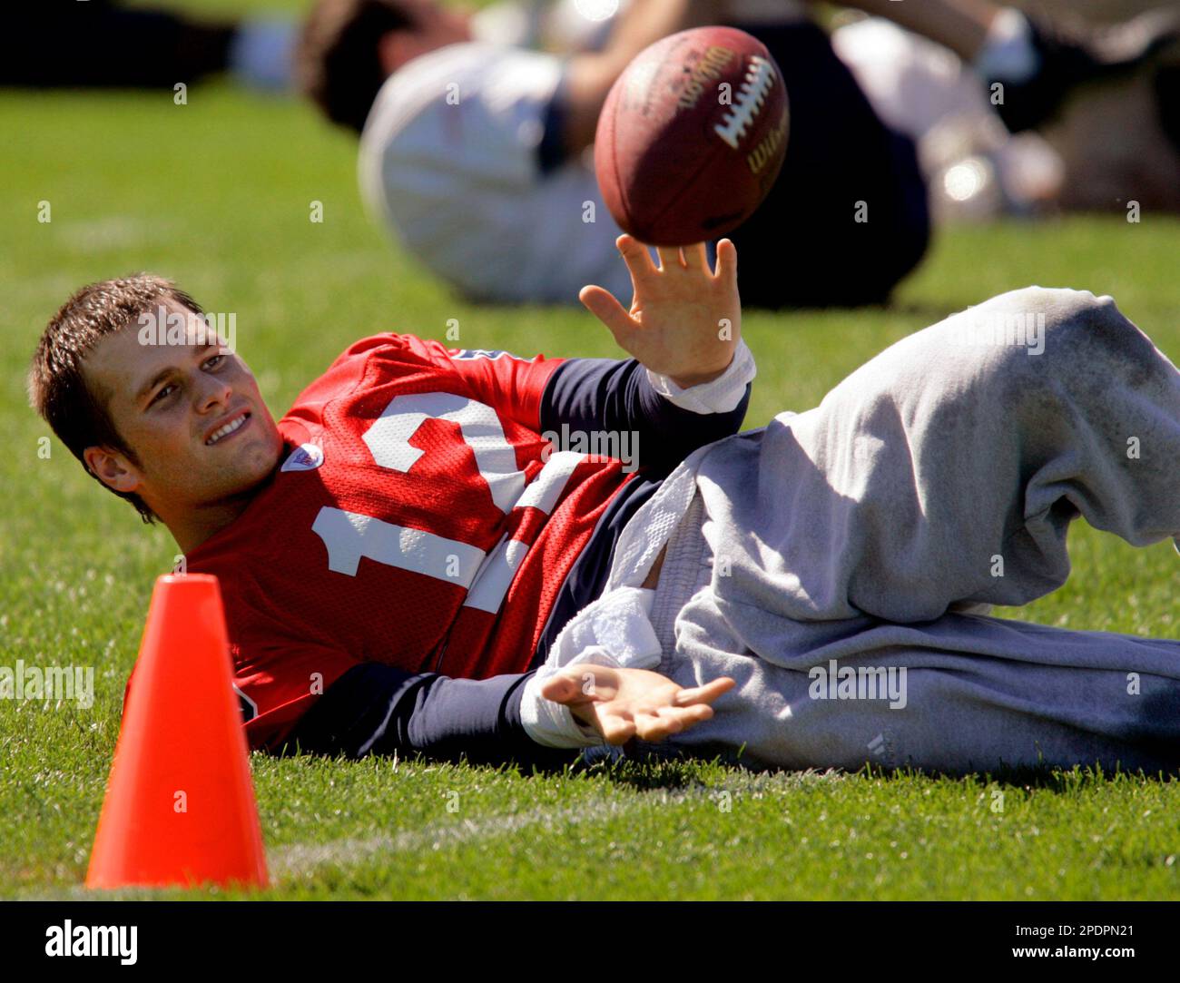 New England Patriots quarterback Tom Brady catches a football thrown to