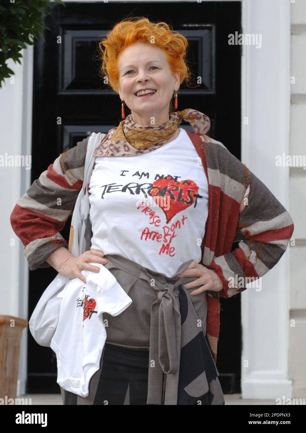 Fashion designer Vivienne Westwood displays her limited edition t shirts and baby grow outfit with the legend I am not a terrorist please don t arrest me