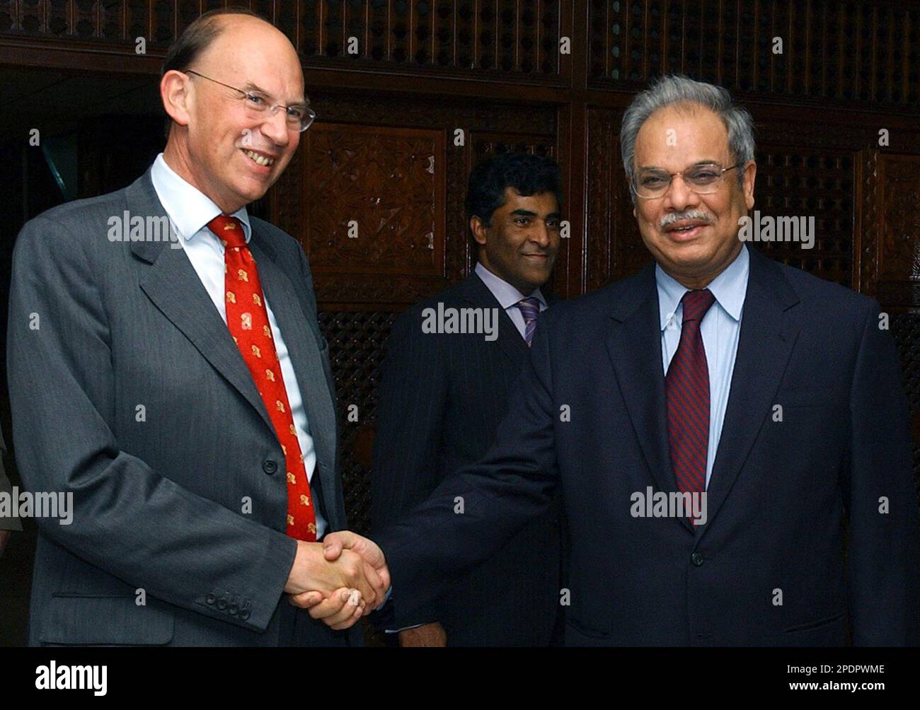 British Permanent Under Secretary Sir Michael Jay, left, shakes hand with Pakistan Foreign Secretary Riaz Mohammad Khan, prior to their talks in Islamabad, Pakistan on Monday, Sept. 26, 2005. They discussed issues of mutual interest. (AP Photo/Naveed Anjum) Stock Photo