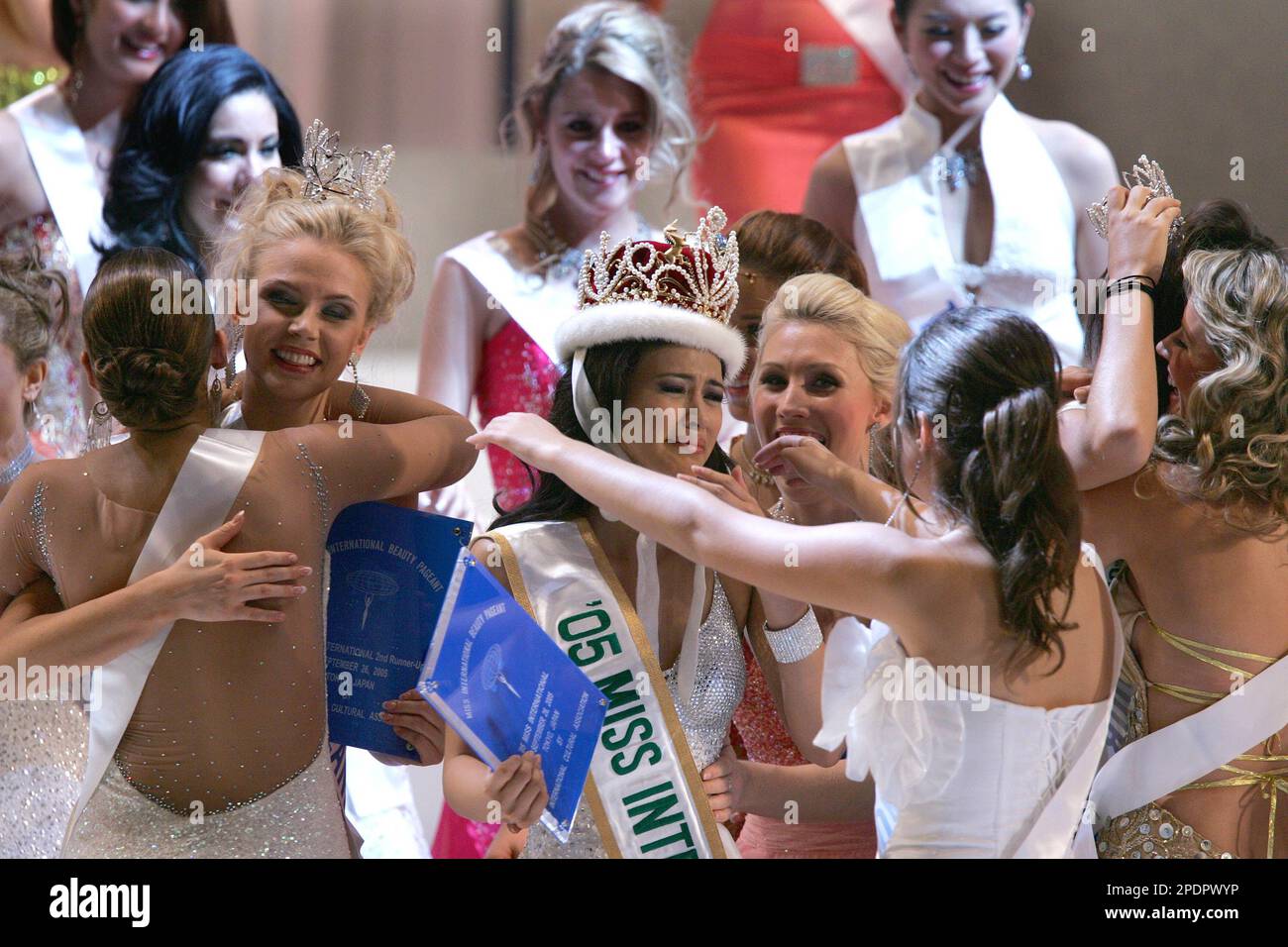 Precious Lara Quigaman of the Philippines, center, reacts as she is named as this year's Miss International while other contestants gather around her for congratulations in Tokyo, Monday, Sept 26, 2005. Also presenting are the runnerup Susanna Laine of Finland, left with crown, and 2nd runner up Yadira Geara of Dominican Republic, right with crown. (AP Photo/Shizuo Kambayashi) Stock Photo
