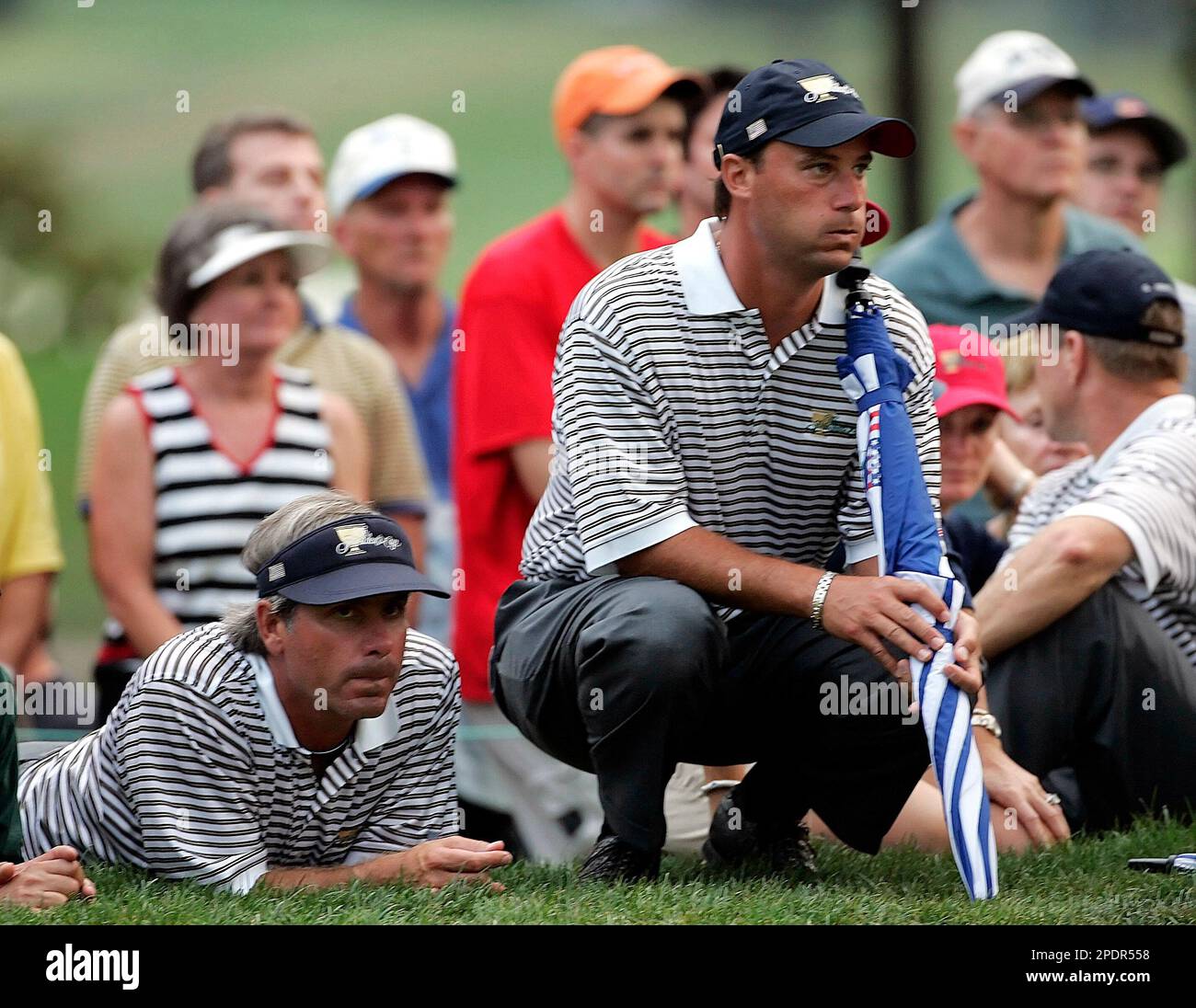 Fred Couples, left, and Chris DiMarco of the United states watch the action on the 18th green during the better-ball matches at the Presidents Cup Friday, Sept