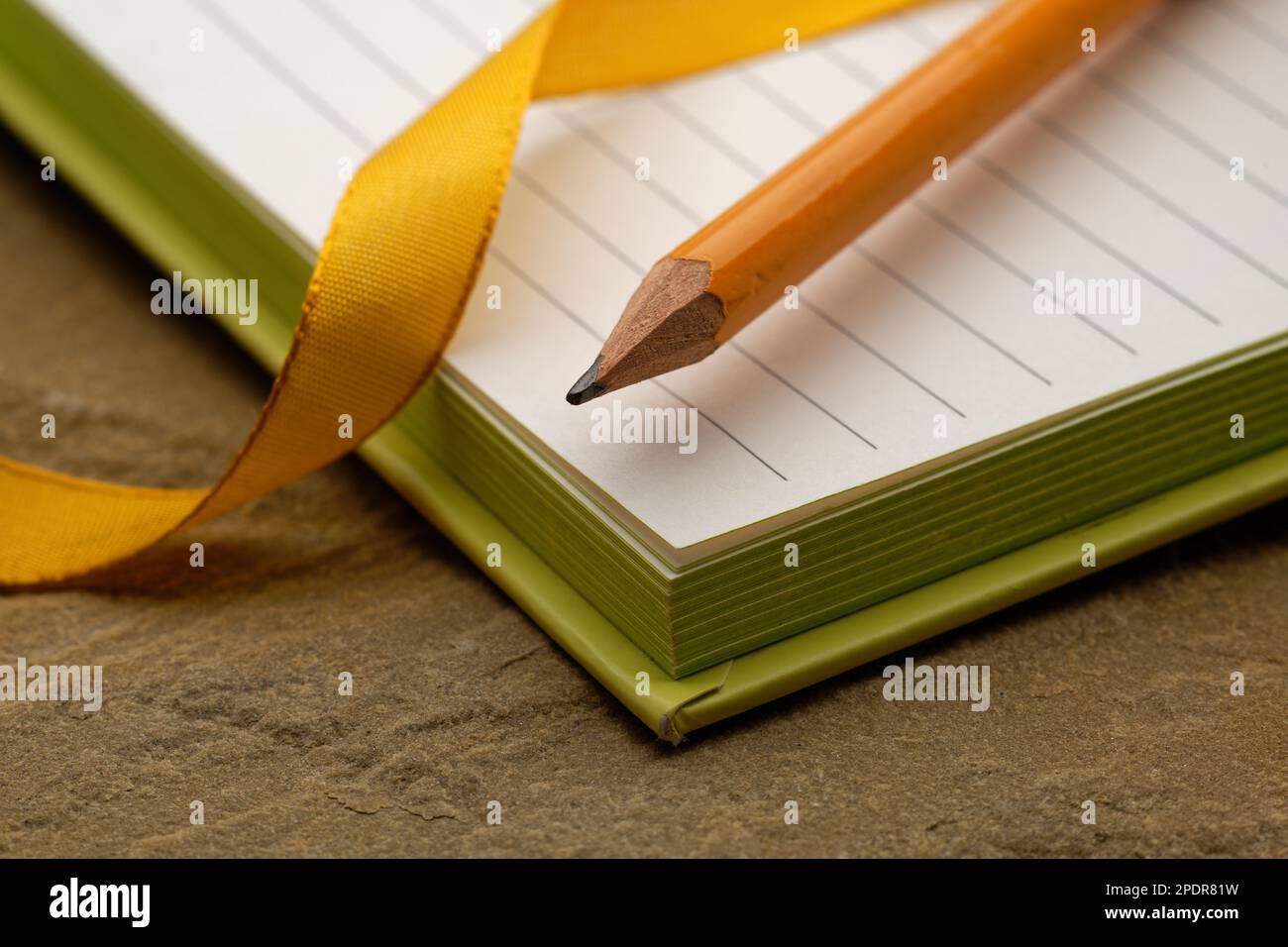 A lined notebook with a pencil. Ready to take notes, sketch ideas and