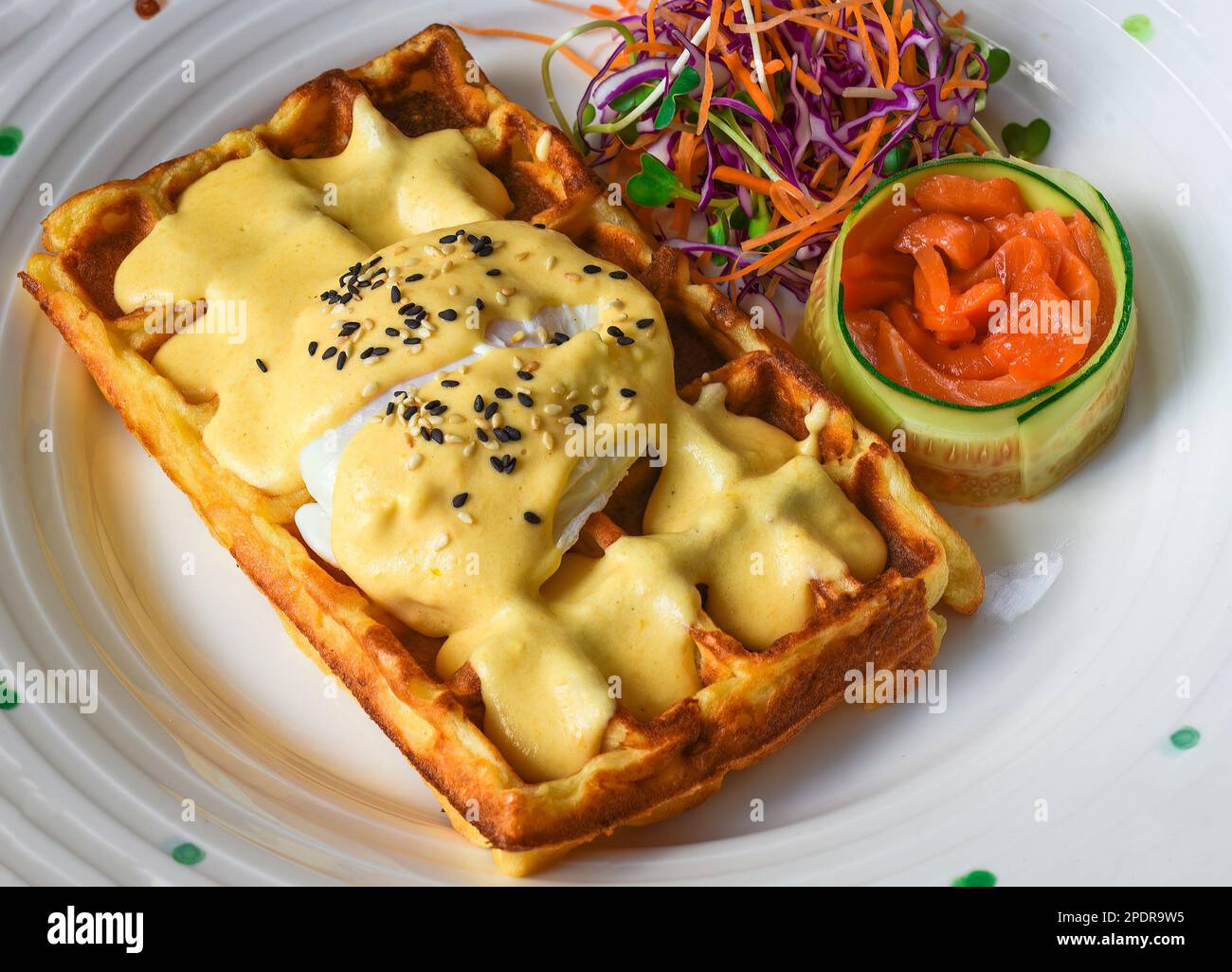 Eggs Benedict (poached eggs) on belgian waffles with salted salmon