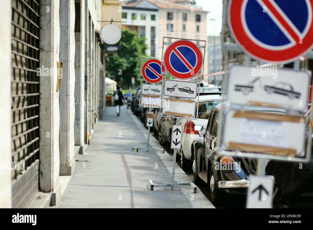 Row of cars parked illegally on street in the center of Milan, a metropolis in Italy's northern Lombardy region. Milan, Lombardy, Italy. Stock Photo
