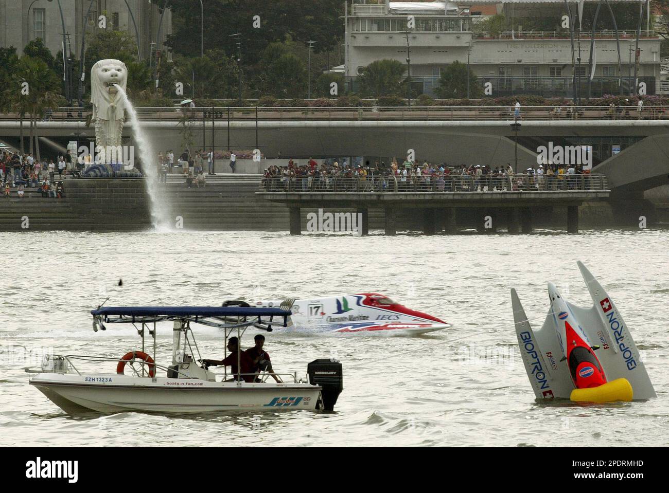 Tamoil F1 Racing Team's boat pilotted by former Italian World Champion  Cappellini Guido is seen capsized after a crash at the second bend while  Dessertenne Phillipe from France blasts past Sunday Sept.