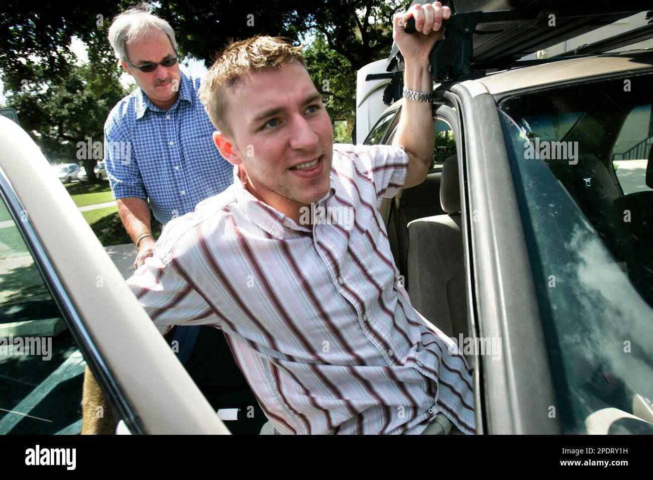 ADVANCE FOR WEEKEND, SEPT. 17-18 ** Christian Bagge, of Dalles, Ore.,  hoists himself from his wheelchair into his car while his father-in-law,  Alan Eagy waits to put the chair in the