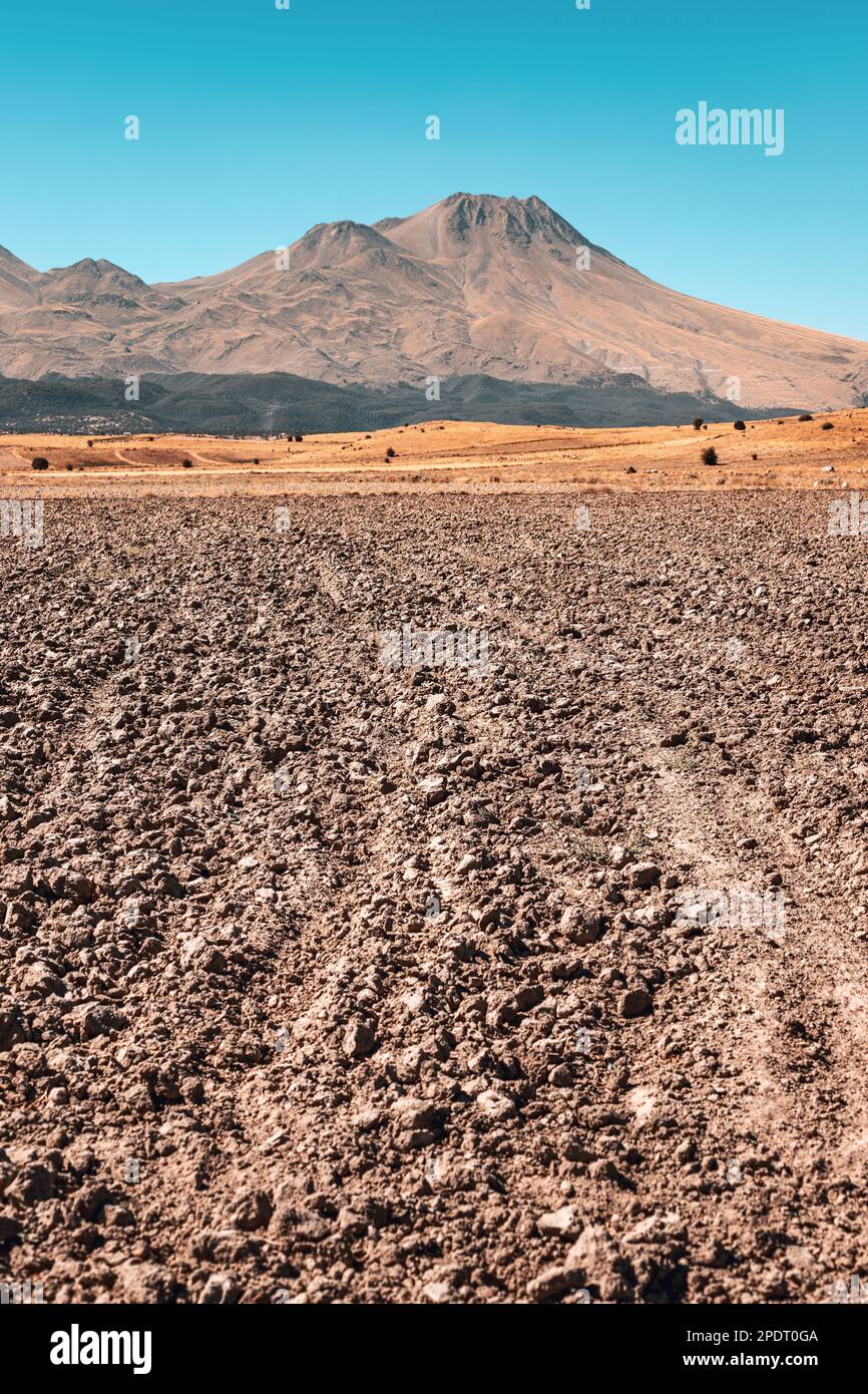 Plowed field and tillage with the extinct volcano Hassan Dag in the background. Agriculture and travel in Turkey Stock Photo