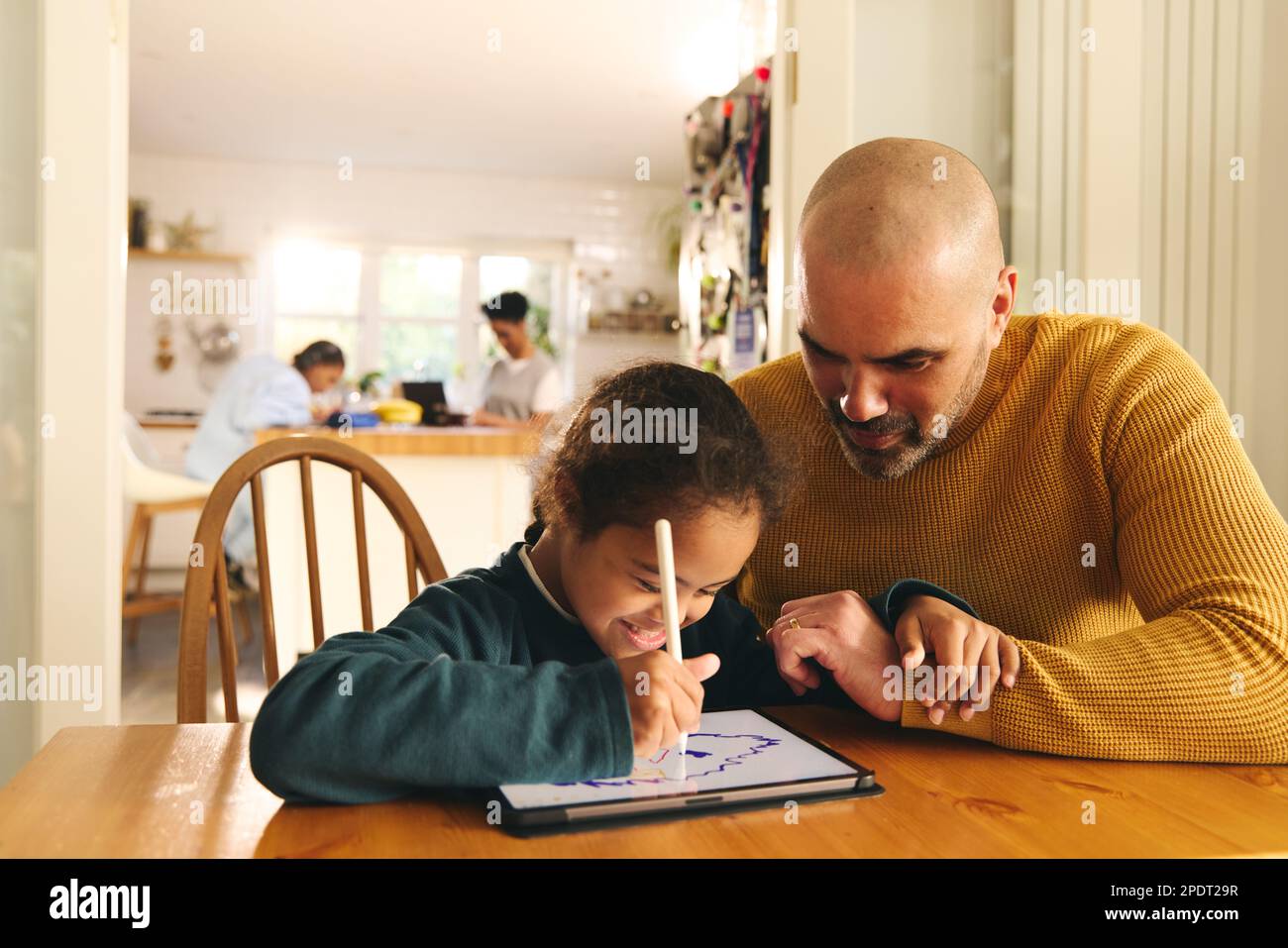 Multiracial father and son with Down syndrome using digital tablet Stock Photo