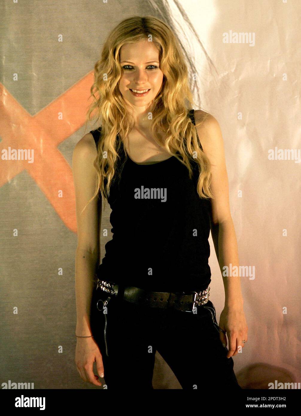 Canadian singer Avril Lavigne poses for photographers during a
