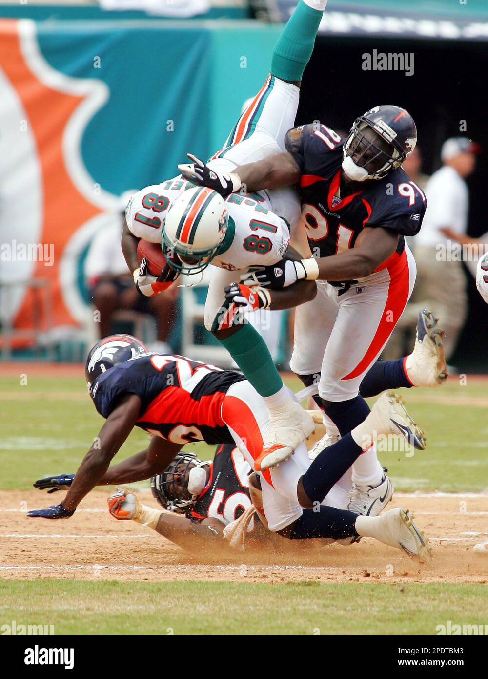 Miami Dolphins Randy McMichael 81 goes over Denver Broncos