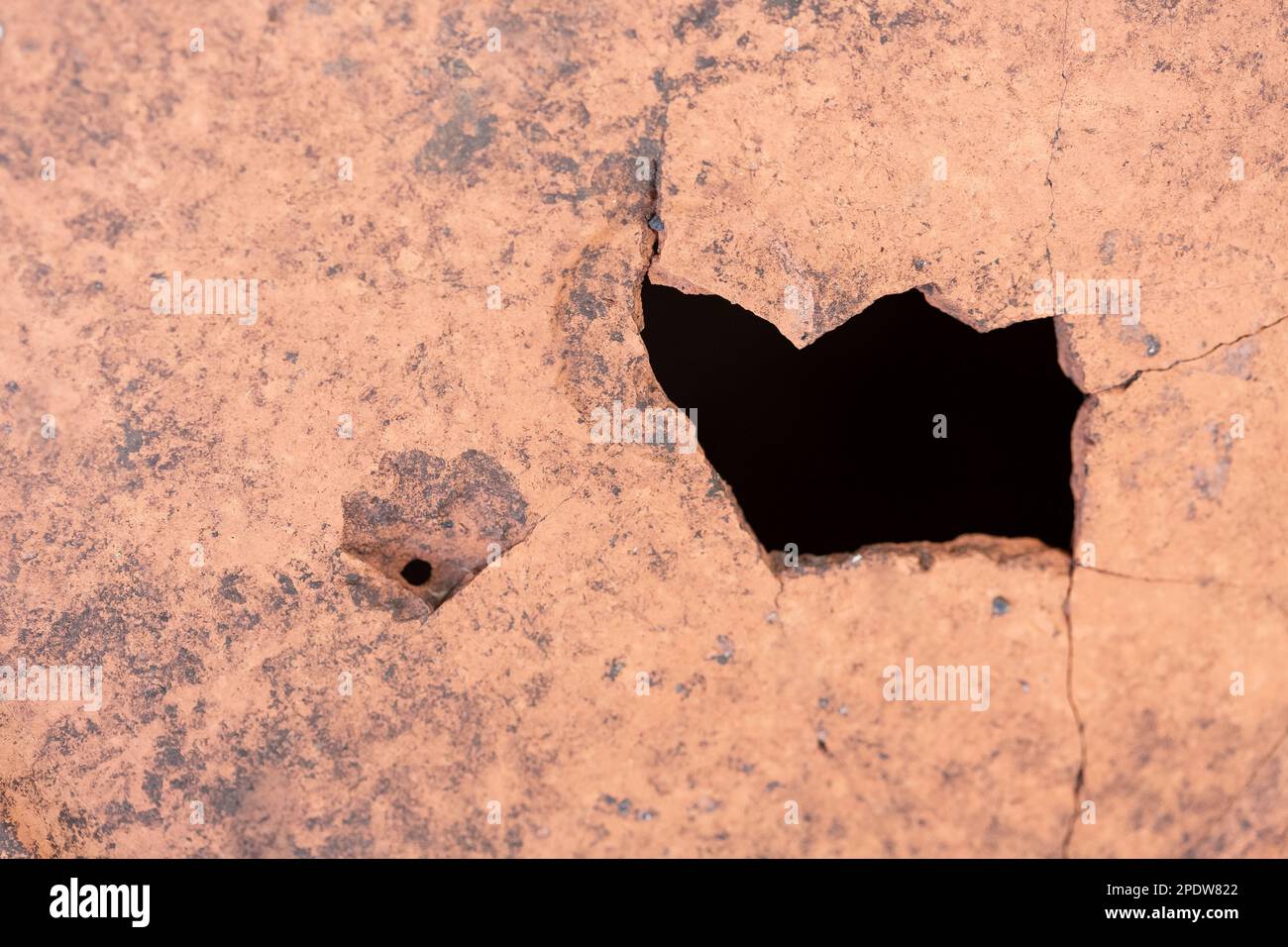 Black hole in a structure, dirty material close up, deep hole - symbol of an fragility and imperfection, failure Stock Photo