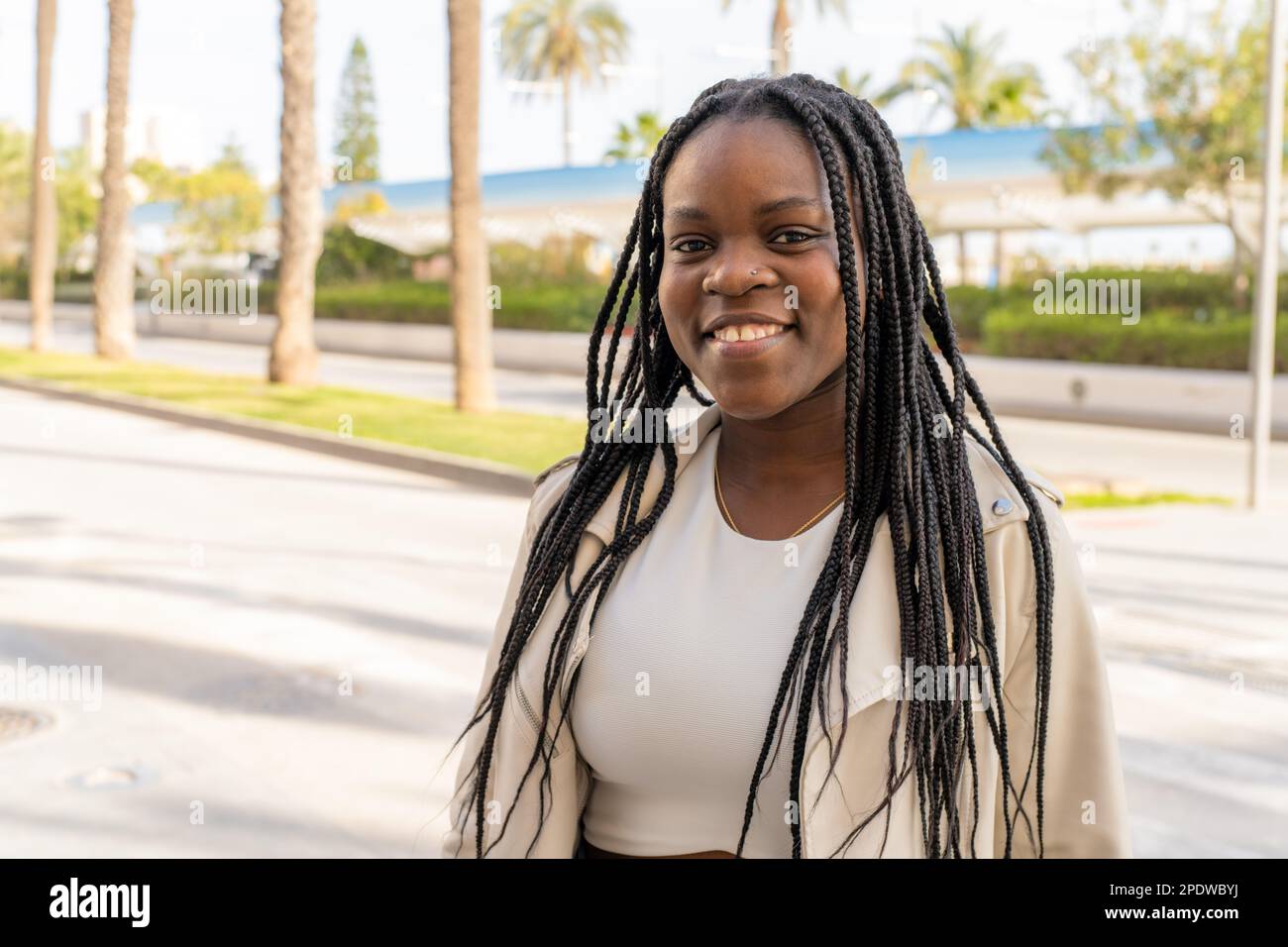 Close up portrait of beautiful young black woman smiling outdoors Stock ...